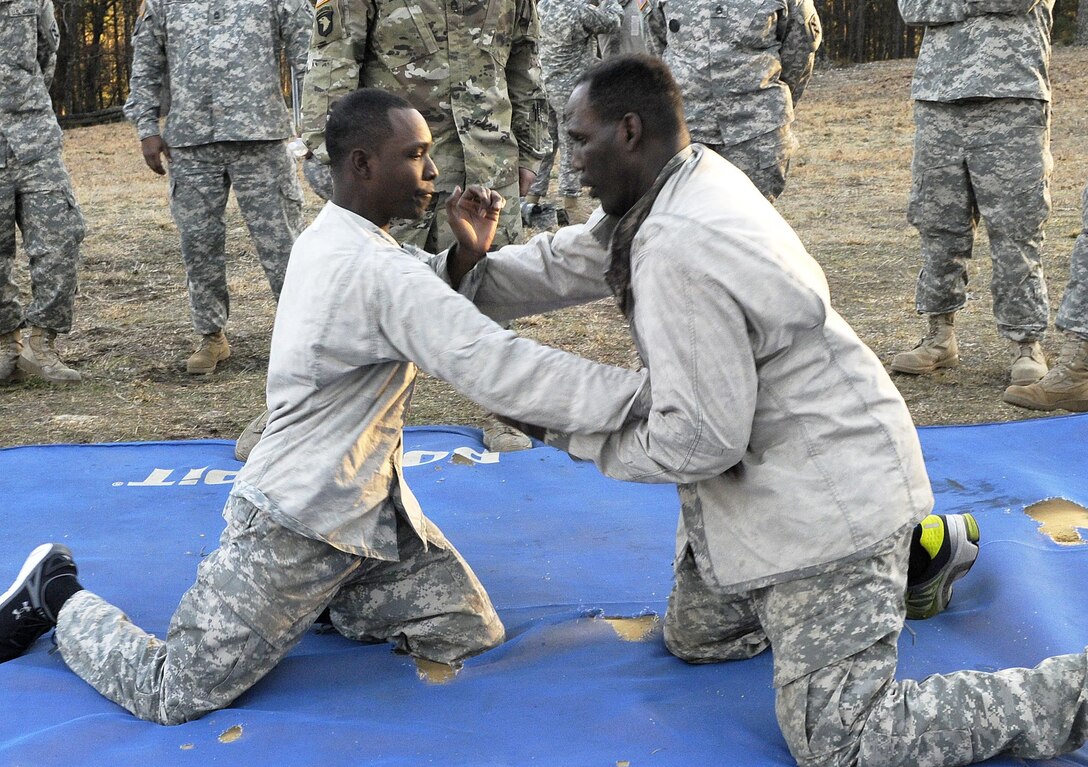 From left, U.S. Army Sgt. Wayne Jones of Gainesville, Ga., a team leader with the 461st Human Resources Company, and Sgt. Lewis Johnson of Elgin, Ill., a squad leader with the 282nd Quartermaster Company, start combatives during the 642nd Regional Support Group's Best Warrior Competition at Fort McClellan, Ala., Feb. 18. (U.S. Army photo by Sgt. 1st Class Gary A. Witte, 642nd Regional Support Group)