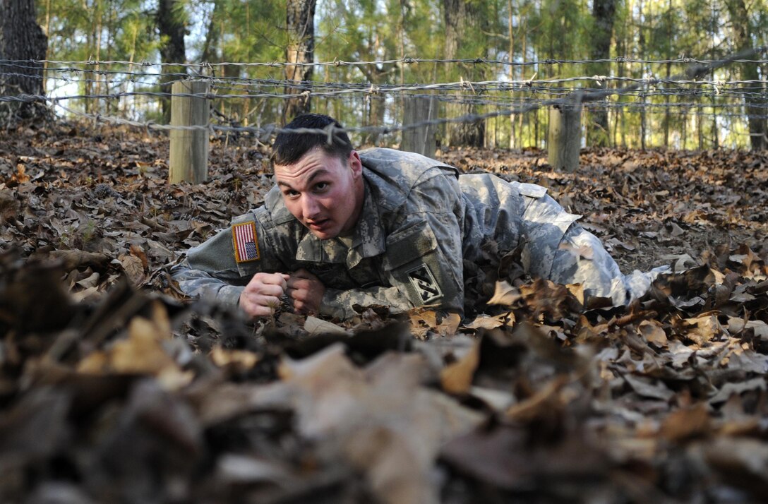 U.S. Army Sgt. Kevin E. Graney of Pemberton, N.J., lead mechanic for the 352nd Combat Sustainment Support Battalion, crawls under barbed wire as part of the 642nd Regional Support Group's Best Warrior Competition at Fort McClellan, Ala., Feb. 18. (U.S. Army photo by Sgt. 1st Class Gary A. Witte, 642nd Regional Support Group)
