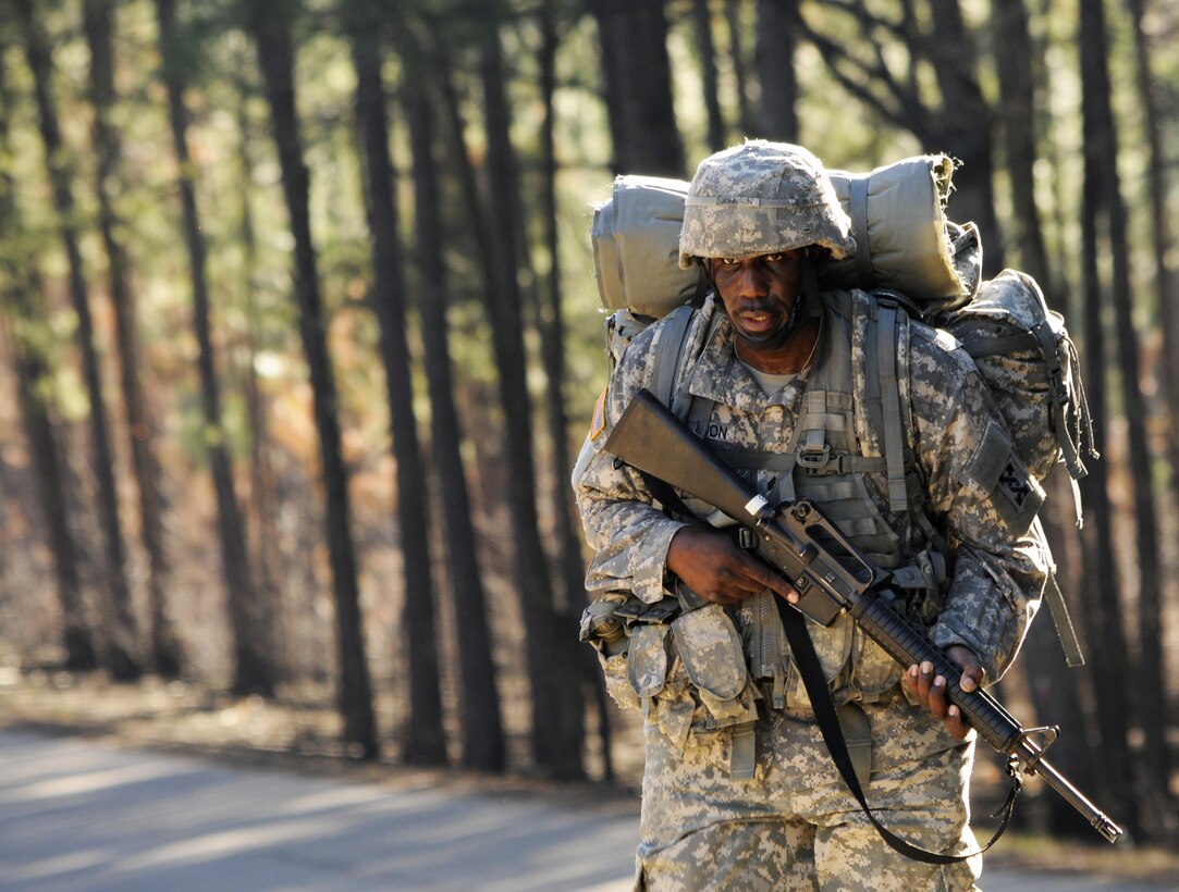 U.S. Army Sgt. Lewis Johnson of Elgin, Ill., a squad leader with the 282nd Quartermaster Company, presses forward during a 12-mile ruck march as part of the 642nd Regional Support Group's Best Warrior Competition at Fort McClellan, Ala., Feb. 19. (U.S. Army photo by Sgt. 1st Class Gary A. Witte, 642nd Regional Support Group)