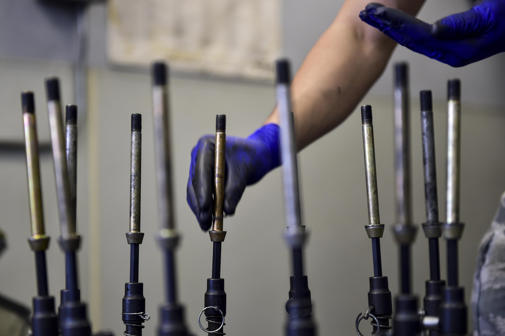 Senior Airman David Marzano, a wheel and tire technician with the 1st Special Operations Maintenance Squadron, places washers on tire bolts while building a C-130 nose tire at Hurlburt Field, Fla., March 30, 2016. The C-130 wheels built by the wheel and tire technicians can be used on the AC-130U Spooky and the MC-130H Combat Talon II. (U.S. Air Force photo by Senior Airman Jeff Parkinson)