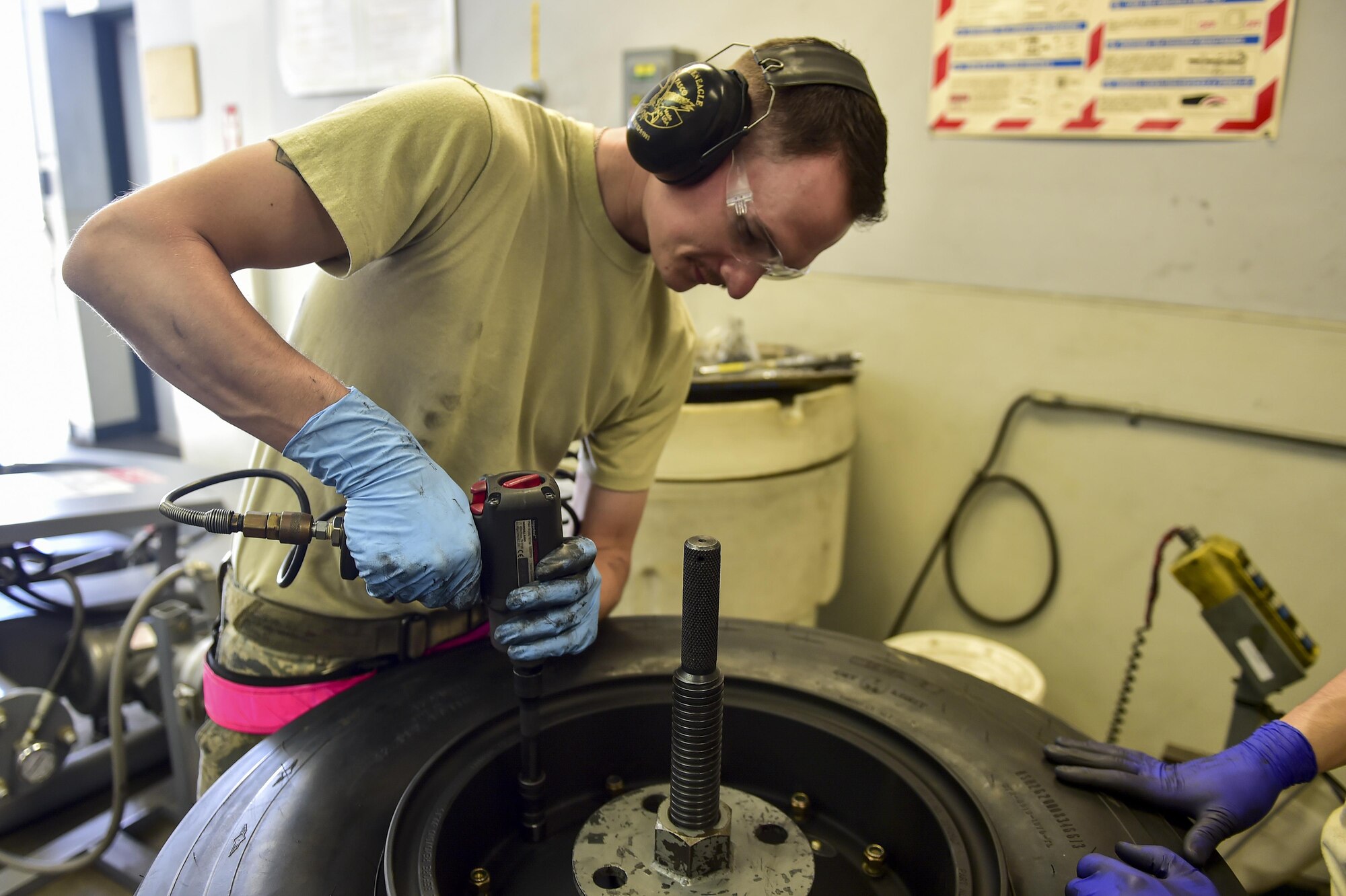 Senior Airman Shane Schubot, a wheel and tire technician with the 1st Special Operations Maintenance Squadron, builds a C-130 nose wheel at Hurlburt Field, Fla., March 30, 2016. The C-130 tires built by the wheel and tire technicians are used on the AC-130U Spooky and the MC-130H Combat Talon II. (U.S. Air Force photo by Senior Airman Jeff Parkinson)