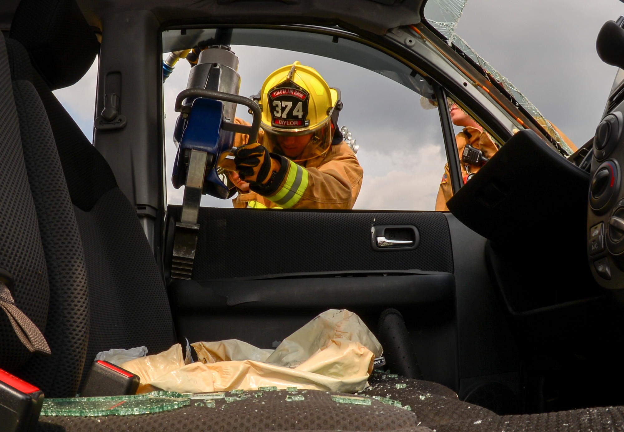 U.S. Air Force Senior Airman Stephen Taylor, 374th Civil Engineer Squadron fire and emergency services flight driver operator, uses Jaws of Life to remove a car door at Yokota Air Base, Japan, March 28, 2016. Fire and emergency services must be capable of supporting and maneuvering Jaws of Life, weighing about 70 pounds, and use it to safely extract pieces of a vehicle. (U.S. Air Force photo by Airman 1st Class Elizabeth Baker/Released) 