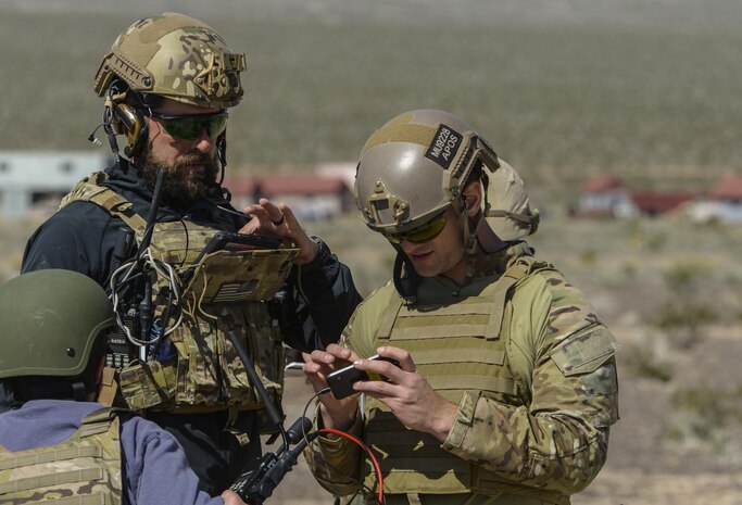 A civilian contractor and a joint terminal attack controller use the Hand Held Link 16, which enables digitally aided close air support integration during the operational assessment of the Hand Held Link 16 radio March 24, 2016, at the Nevada Test and Training Range. Link 16 was originally designed for air-to-air missions, but the technology has made the transition to ground forces providing JTACs advantages on the battlefield that they didn’t previously have. (U.S. Air Force photo by Airman 1st Class Nathan Byrnes)