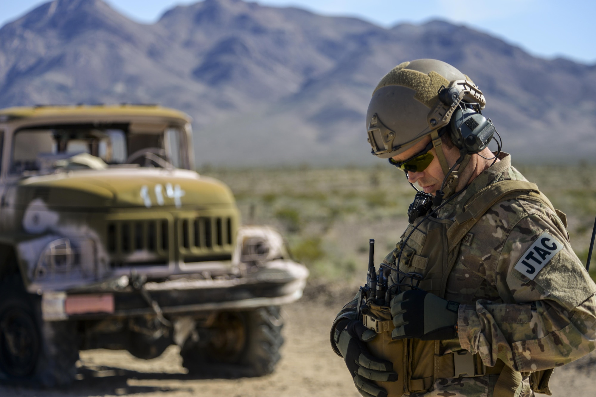 Capt. Richard Waters, 605th Test and Evaluation Squadron, Hurlburt Field, Florida, tactical air control party air liaison officer, joint terminal attack controller, checks his equipment during the operational assessment of the Hand Held Link 16 radio March 24, 2016, at the Nevada Test and Training Range. The HHL16 provides a tactical data link to joint terminal attack controller and pilots that enables digitally aided close air support integration. (U.S. Air Force photo by Airman 1st Class Nathan Byrnes)
