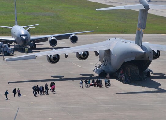 Families of U.S. Airmen and Defense Department civilians board a C-17 Globemaster III during an ordered departure March 30, 2016, at Incirlik Air Base, Turkey. On March 29, 2016, the secretary of defense, in coordination with the secretary of state, ordered the departure of all DOD dependents assigned to Incirlik AB. (U.S. Air Force photo/Senior Airman John Nieves Camacho)