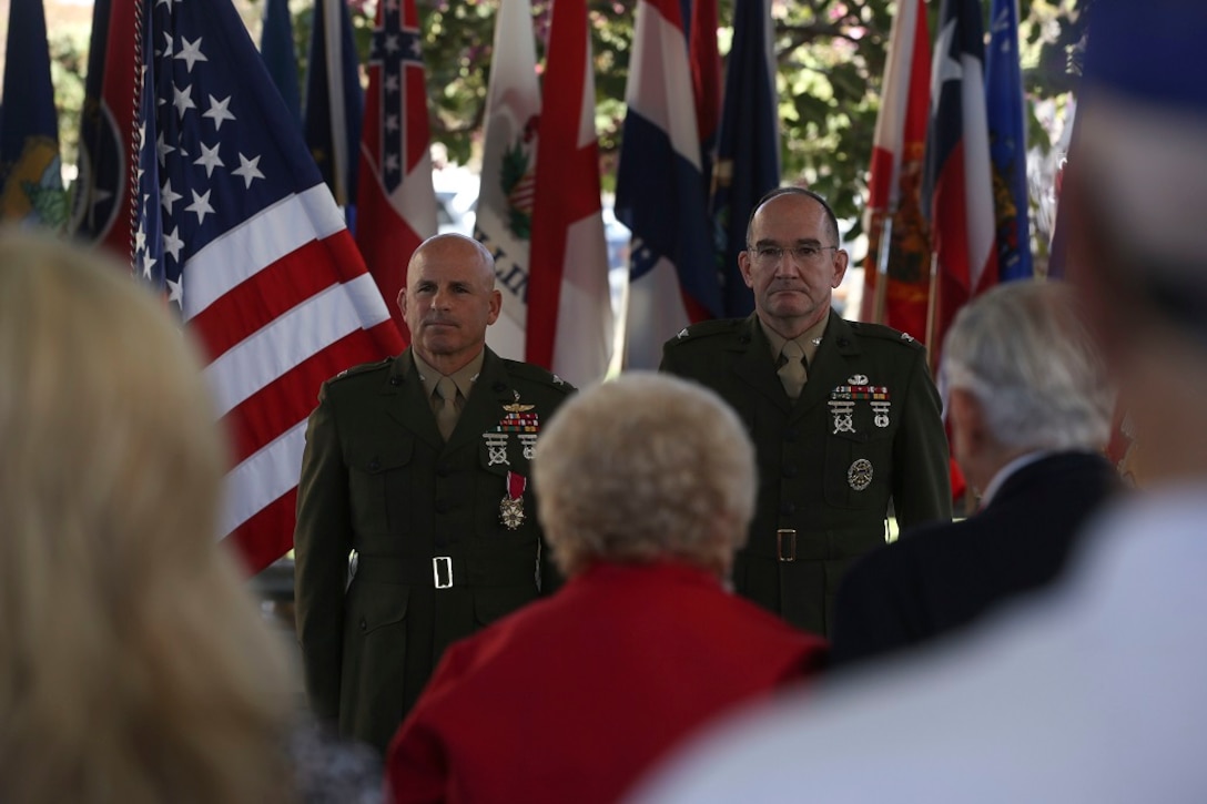 MARINE CORPS BASE CAMP PENDLETON, Calif. – Colonel Willard ‘Willy’ Buhl (left) and Dwight Trafton (right), a retired colonel, stand at attention for the conclusion of Col. Buhl’s retirement ceremony on Feb. 12, at Camp Pendleton, Calif. The ceremony was to commemorate Buhl’s 34 years of dedicated service to the United States Marine Corps. Buhl was formerly the director of Expeditionary Operations Training Group, I Marine Expeditionary Force and is from Los Gatos, Calif. (U.S. Marine Corps photo by Cpl. Angel Serna/Released)
