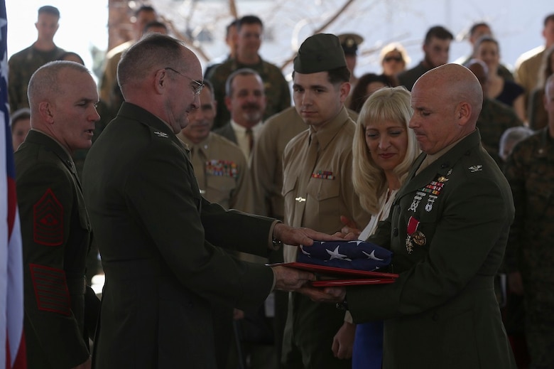 MARINE CORPS BASE CAMP PENDLETON, Calif. – Colonel Willard ‘Willy’ Buhl is awarded a Distinguished Service Medal and given an honorable discharge certificate along with a commemorative flag for his retirement ceremony on Feb. 12, at Camp Pendleton, Calif. The ceremony was to commemorate Buhl’s 34 years of dedicated service to the United States Marine Corps. Buhl was formerly the director of Expeditionary Operations Training Group, I Marine Expeditionary Force and is from Los Gatos, Calif. (U.S. Marine Corps photo by Cpl. Angel Serna/Released)