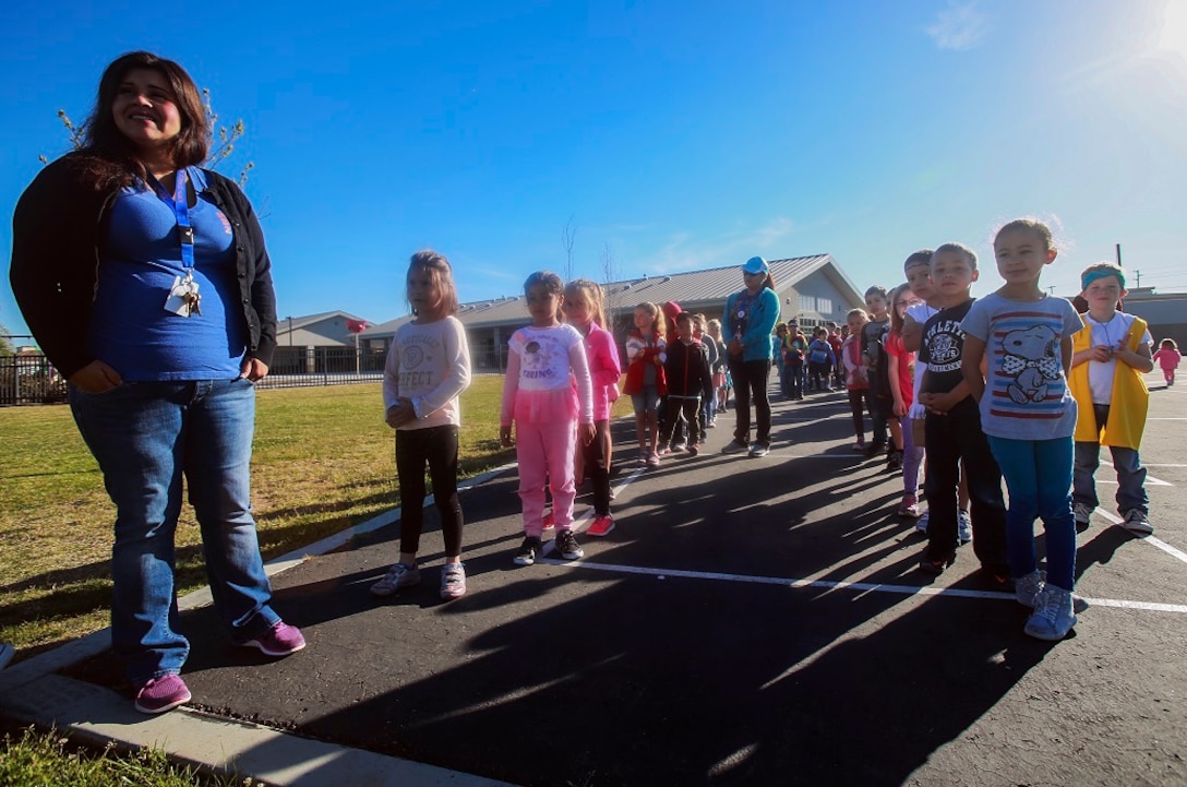 MARINE CORPS BASE CAMP PENDLETON, Calif. – Lydia Meza-Magallanes lines up her students for the Physical Education Fitness Challenge at North Terrace Elementary, March 25, 2016. Approximately 30 Marine volunteers with the Single Marine Program facilitated a series of exercises and competitions including an obstacle course relay race and tug-of-war. The challenge encourages children to stay active and helps Marines engage with their local community. Meza-Magallanes, a native of Fillmore, Calif., is a kindergarten teacher at North Terrace Elementary. (U.S. Marine Corps photo by Lance Cpl. Caitlin Bevel/RELEASED)