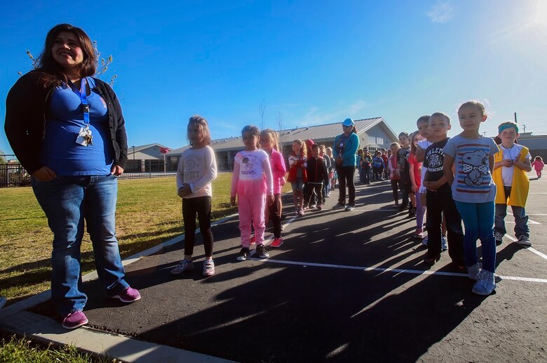 MARINE CORPS BASE CAMP PENDLETON, Calif. – Lydia Meza-Magallanes lines up her students for the Physical Education Fitness Challenge at North Terrace Elementary, March 25, 2016. Approximately 30 Marine volunteers with the Single Marine Program facilitated a series of exercises and competitions including an obstacle course relay race and tug-of-war. The challenge encourages children to stay active and helps Marines engage with their local community. Meza-Magallanes, a native of Fillmore, Calif., is a kindergarten teacher at North Terrace Elementary. (U.S. Marine Corps photo by Lance Cpl. Caitlin Bevel/RELEASED)