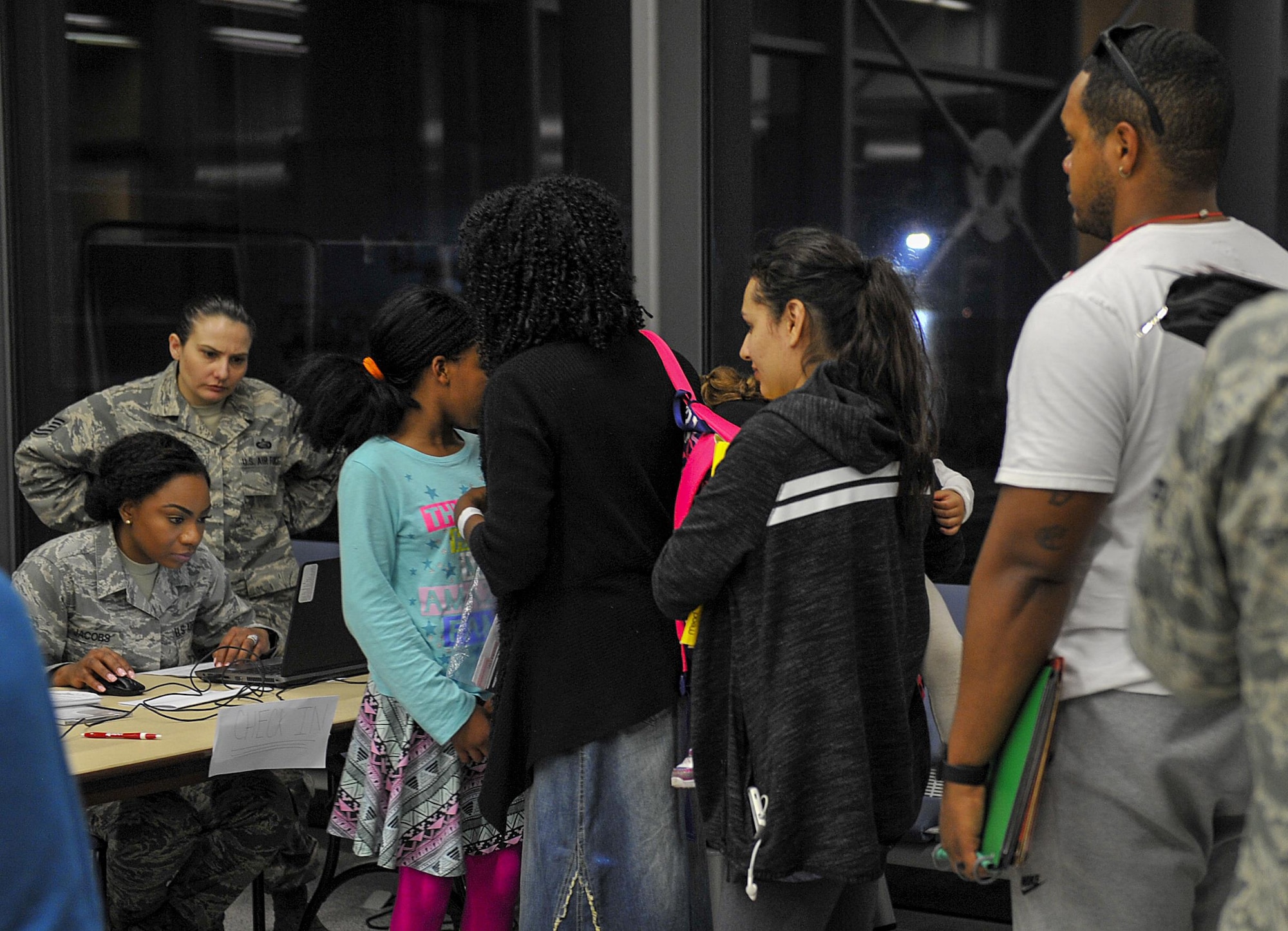 Families arriving from Turkey check-in March 31, 2016, at Ramstein Air Base, Germany. Many agencies provided assistance by offering food, transportation and any needs families arriving from military bases in Turkey may have required. (U.S. Air Force photo/Senior Airman Larissa Greatwood)