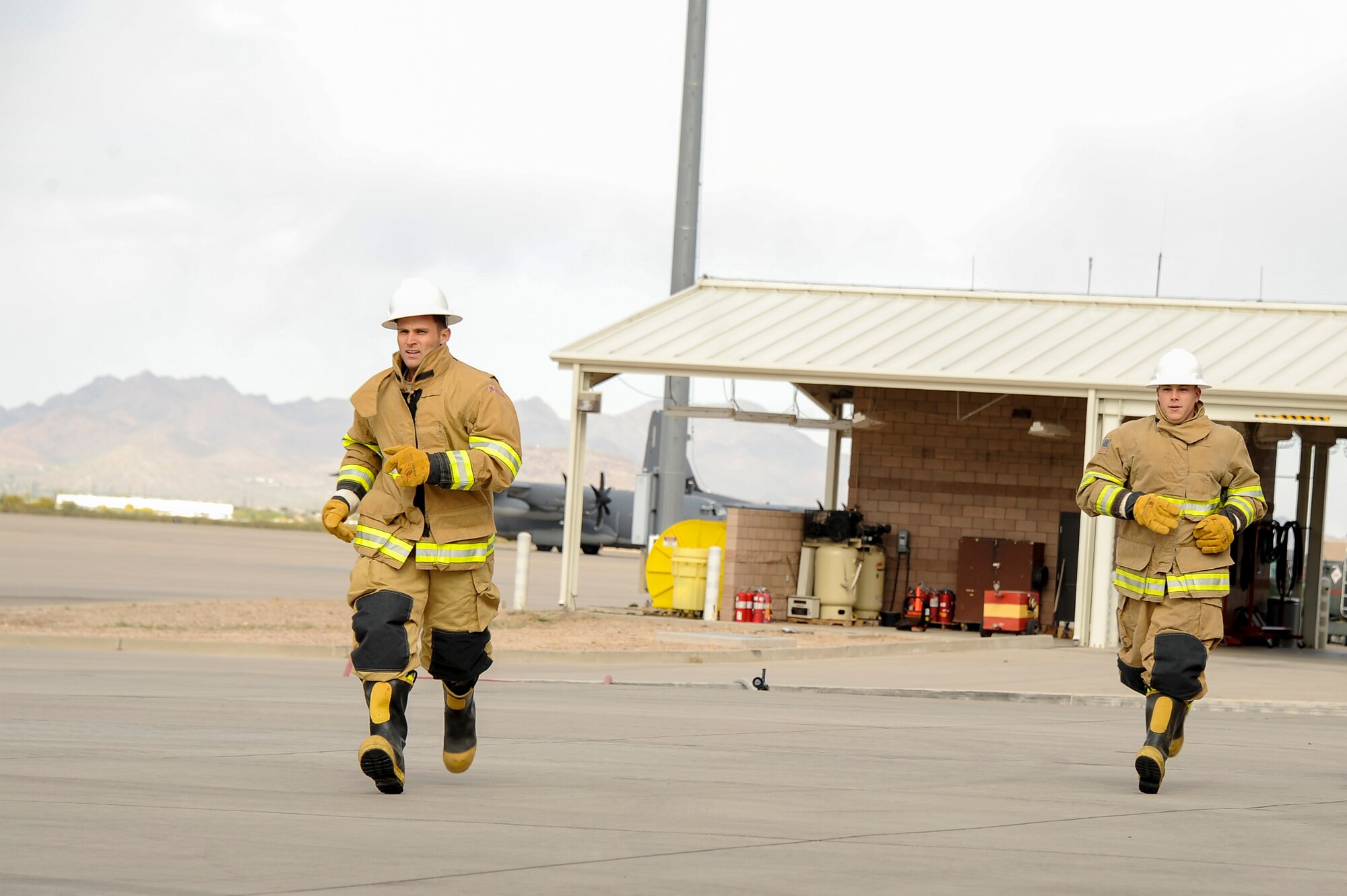U.S. Air Force 2nd Lt. Justin Trampota, 355th Logistics Readiness Squadron officer in charge of vehicle management, and Airman 1st Class Dylan Nigren, 355th LRS fire truck and refueling journeyman, run towards the next station during the Comprehensive Airman Fitness Month Fire Department Fitness Challenge at Davis-Monthan Air Force Base, Ariz., March 31, 2016.  The event was hosted by the 355th Civil Engineer Squadron’s explosive ordnance disposal and fire emergency service flights in coordination with the Community Support Center with the objectives of embracing team building, showing the links between different CAF pillars, and encouraging Airmen to challenge themselves. (U.S. Air Force photo by Airman 1st Class Mya M. Crosby/Released)