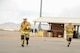 U.S. Air Force 2nd Lt. Justin Trampota, 355th Logistics Readiness Squadron officer in charge of vehicle management, and Airman 1st Class Dylan Nigren, 355th LRS fire truck and refueling journeyman, run towards the next station during the Comprehensive Airman Fitness Month Fire Department Fitness Challenge at Davis-Monthan Air Force Base, Ariz., March 31, 2016.  The event was hosted by the 355th Civil Engineer Squadron’s explosive ordnance disposal and fire emergency service flights in coordination with the Community Support Center with the objectives of embracing team building, showing the links between different CAF pillars, and encouraging Airmen to challenge themselves. (U.S. Air Force photo by Airman 1st Class Mya M. Crosby/Released)