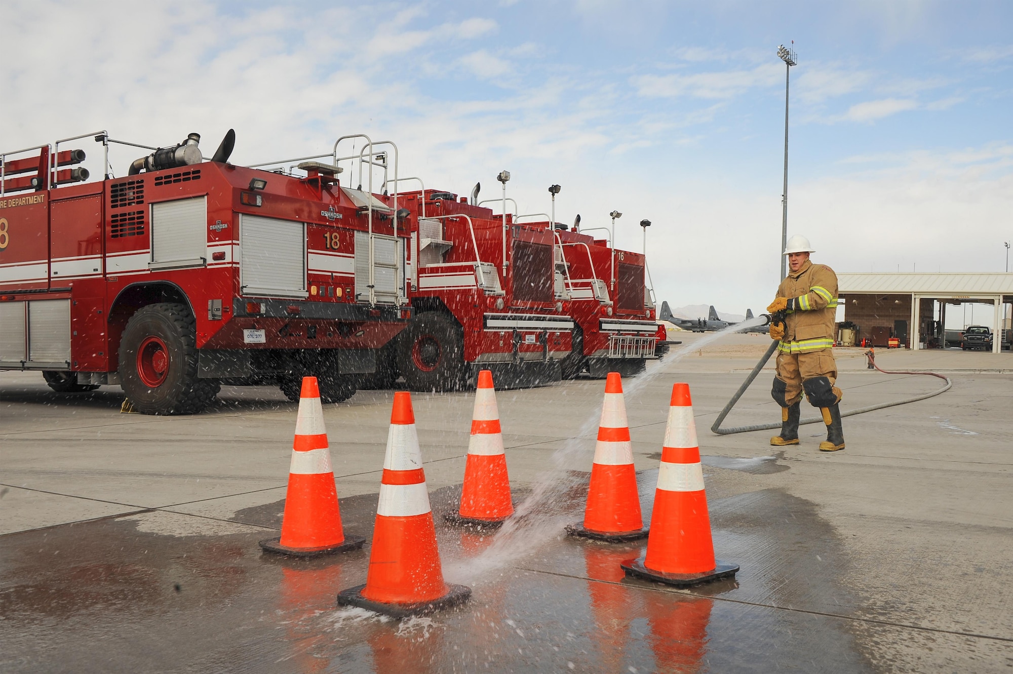 U.S. Air Force Airman 1st Class Dylan Nigren, 355th Logistics Readiness Squadron fire truck and refueling journeyman, utilizes a fire hose during the Comprehensive Airman Fitness Month Fire Department fitness challenge at Davis-Monthan Air Force Base, Ariz., March 31, 2016. Participants demonstrated their physical resilience through exercises such as dummy drags, tool carries and fire hydrant charging.. (U.S. Air Force photo by Airman 1st Class Mya M. Crosby/Released)