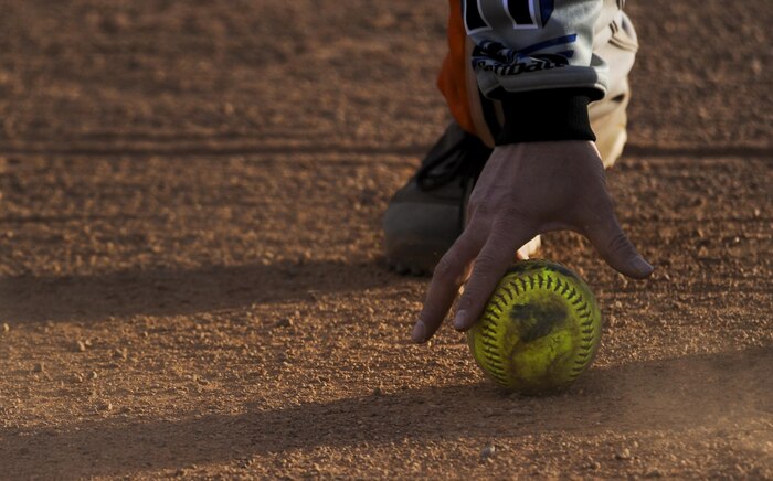 A member of the 57th Operations Support Squadron fields a ball during an intermural game against the 30th Reconnaissance Squadron at Nellis Air Force Base, Nev., March 28, 2016. With the season beginning in the middle of March, the league is planned to be finished during May before the summer temperatures get to hot to play. (U.S. Air Force photo by Airman 1st Class Kevin Tanenbaum)