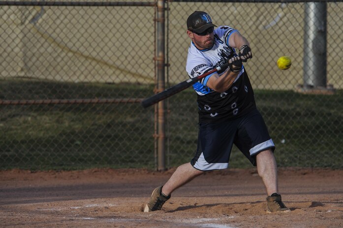 A team member from the 57th Maintenance Squadron Munitions Flight intramural softball team swings at a pitch during a practice before a game at Nellis Air Force Base, Nev., March 28, 2016. The Warrior Fitness Center hopes that Airmen can have fun playing softball; the intramural league is also used as a way to build on the four pillars of comprehensive fitness. (U.S. Air Force photo by Airman 1st Class Kevin Tanenbaum)