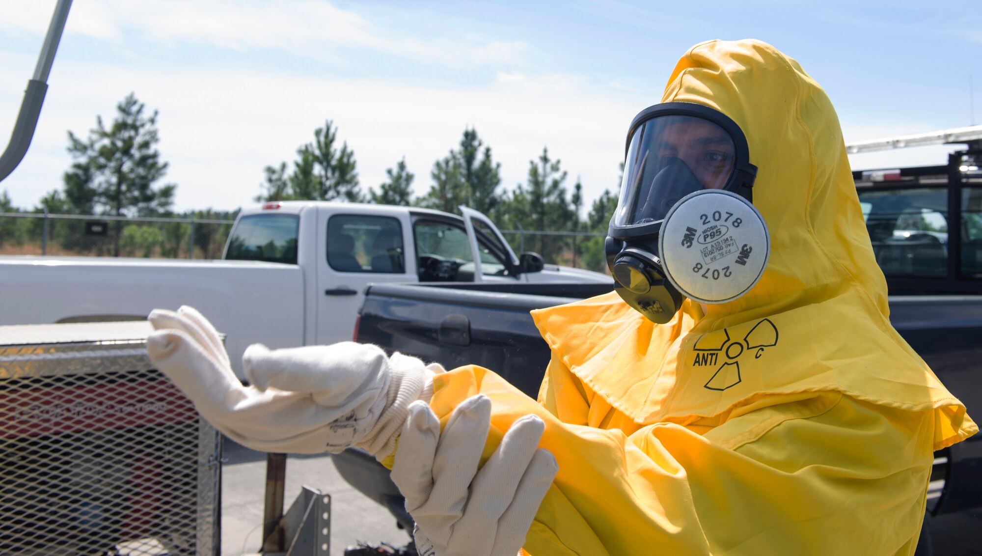 U.S. Air Force Senior Airman Matthias Tooman, 23d Civil Engineer Squadron emergency management manager, dons an anticontamination suit during a radiation response exercise, March 30, 2016, at Moody Air Force Base, Ga. The garment protects first responders from encountering hazardous material. (U.S. Air Force photo by Airman 1st Class Greg Nash/Released)
