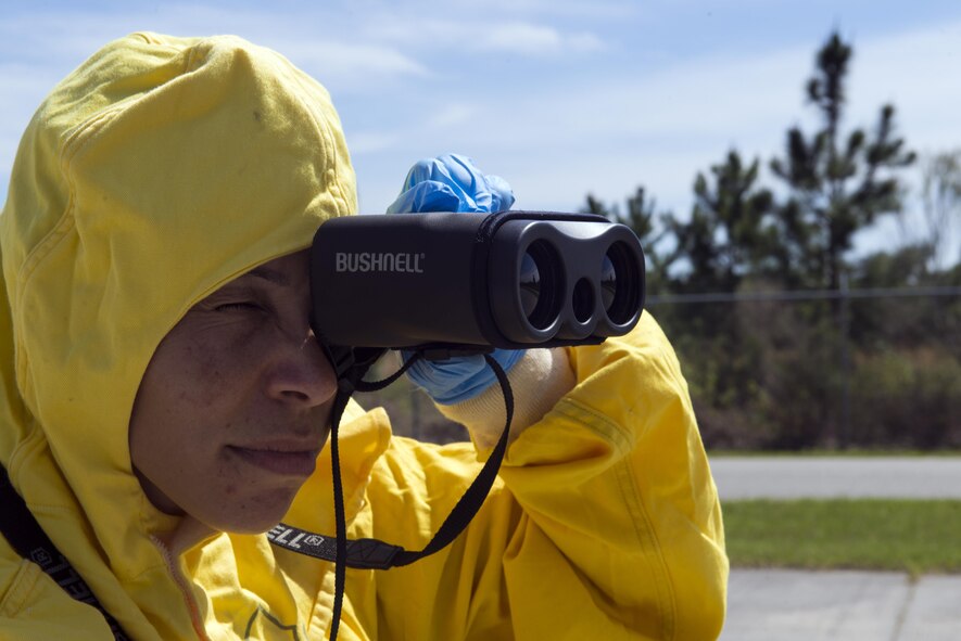 U.S. Air Force Tech. Sgt. Nicole Dunlap, 23d Aerospace Medicine Squadron bioenvironmental engineering flight chief, looks through long-range binoculars during a radiological response exercise, March 30, 2016, at Moody Air Force Base, Ga. During the exercise, the bio flight and the 23d Civil Engineer Squadron emergency management specialists completed a radial plot survey to determine the focal point of radioactive contamination. (U.S. Air Force photo by Airman 1st Class Greg Nash/Released)
