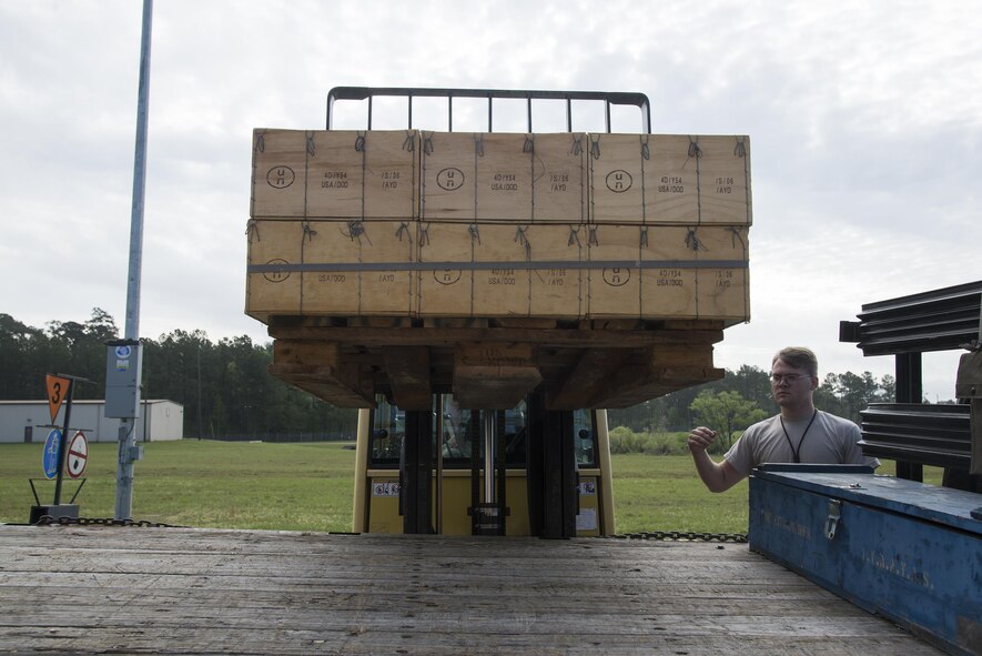 U.S. Air Force Airman 1st Class Wesley Azbell, 23d Equipment Maintenance Squadron munitions storage crew chief, guides a forklift, March 31, 2016, at Moody Air Force Base, Ga. The pallet contained small arms practice ammunition used during combat arms training. (U.S. Air Force photo by Airman 1st Class Janiqua P. Robinson/Released)
