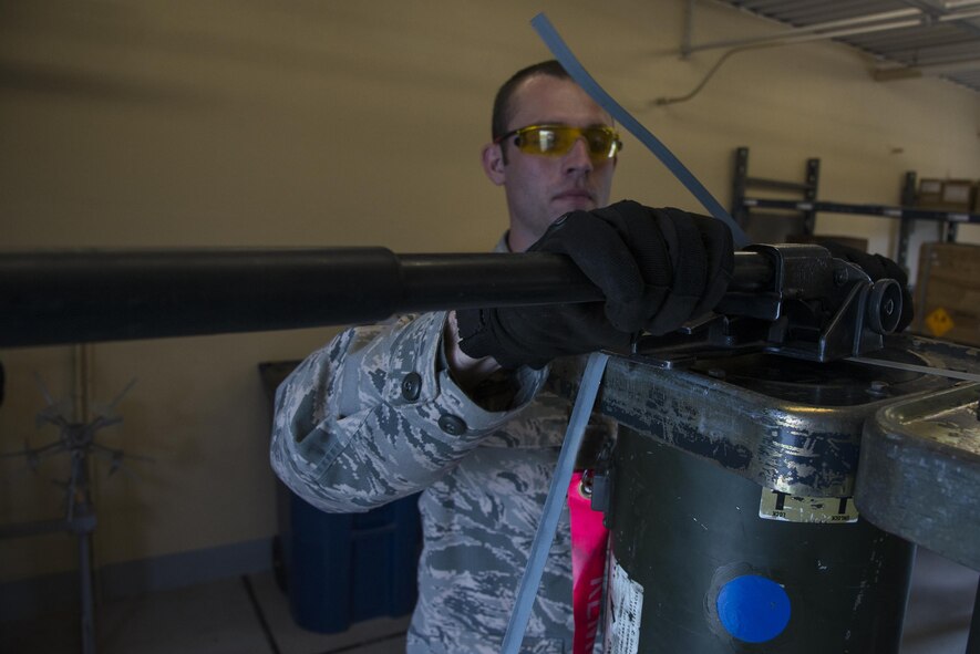 U.S. Air Force Staff Sgt. Jeb Snow, 23d Equipment Maintenance Squadron munitions inspector, secures munitions to a pallet, March 31, 2016, at Moody Air Force Base, Ga. Inspectors package munitions for transport after inspecting and clearing them. (U.S. Air Force photo by Airman 1st Class Janiqua P. Robinson/Released)