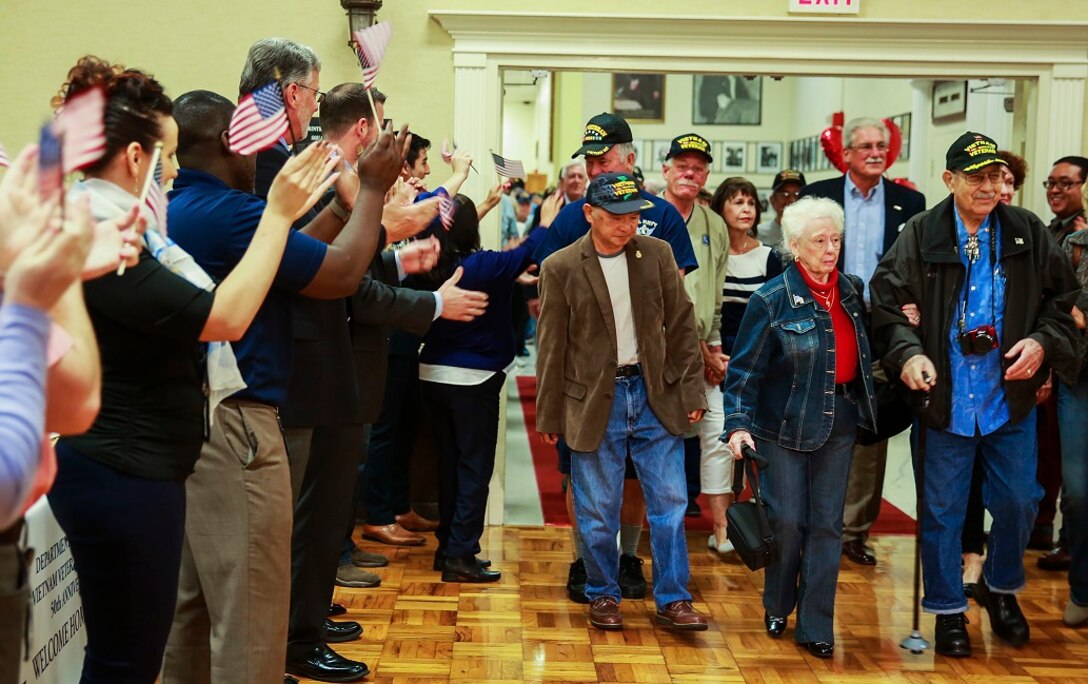 SAN DIEGO – Supporters cheer as veterans of the Vietnam War enter the room at the Scottish Rite Event Center in San Diego March 29, 2016. The center hosted a Vietnam War 50th anniversary commemoration as part of the presidential proclamation of commemoration for Vietnam veterans, which extends from Memorial Day 2012, through Veterans Day 2025. Hundreds of veterans attended the event where dozens of organizations, such as the San Diego and San Marcos Vet Centers, came to show their support and present resources available to veterans. According to Karen Schoenfeld-Smith, the team leader for the San Diego Vet Center, being in war changed these veterans and after the less than warm welcome they received upon their return, it is important as a community to show that their sacrifice is appreciated. (U.S. Marine Corps photo by Lance Cpl. Caitlin Bevel/RELEASED)