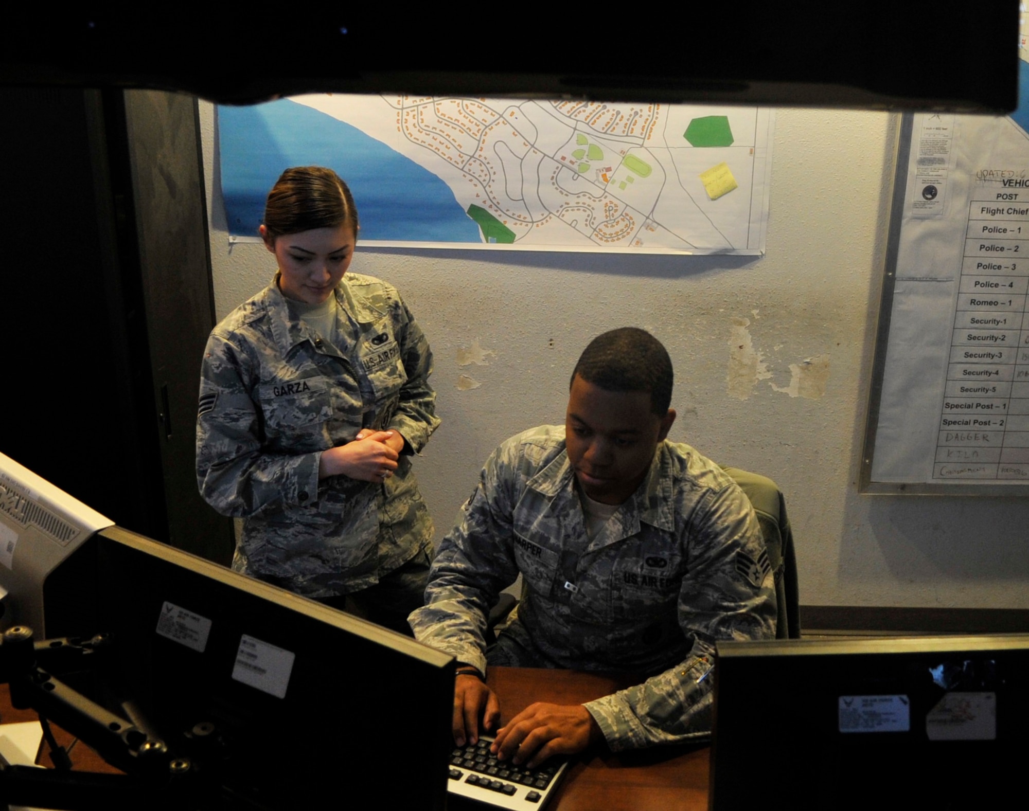 Senior Airman Baso Harper, 325th Security Forces Squadron electronic security systems NCO in charge, conducts daily status checks on 2,805 alarm points March 7, 2016, at the Base Defense Operations Center. Harper is in charge of the electronic security systems section and monitors 2,805 alarm points, 102 alarmed areas and nine restricted areas. He also assures alarms are at those areas at all times, and makes sure that approximately 200 base personnel do quarterly alarm checks on their facilities. (U.S. Air Force photo by Senior Airman Sergio A. Gamboa/Released)