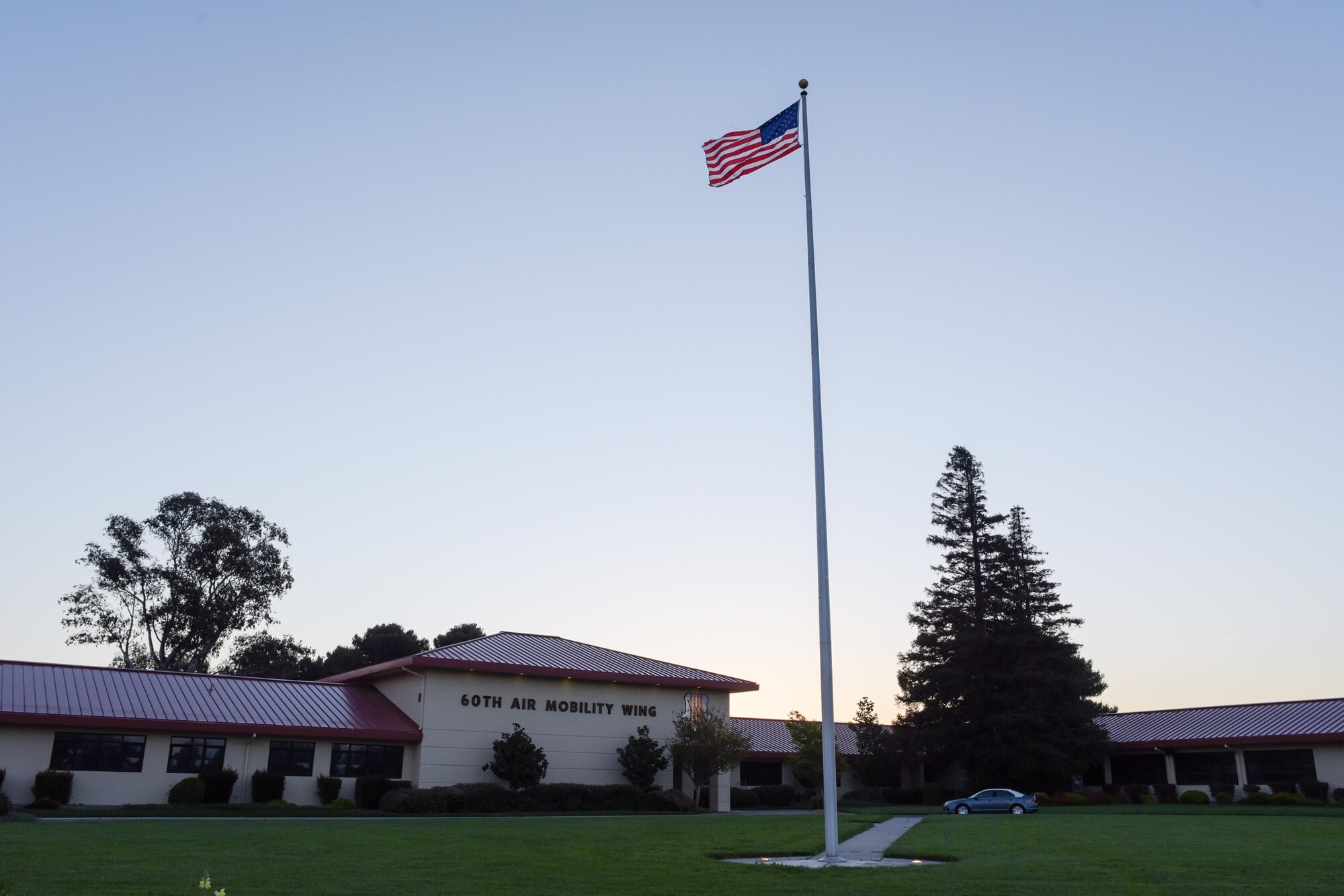 The American flag flies over the 60th Air Mobility Wing headquarters at Travis AFB, California. (U.S. Air Force photo by Ken Wright)