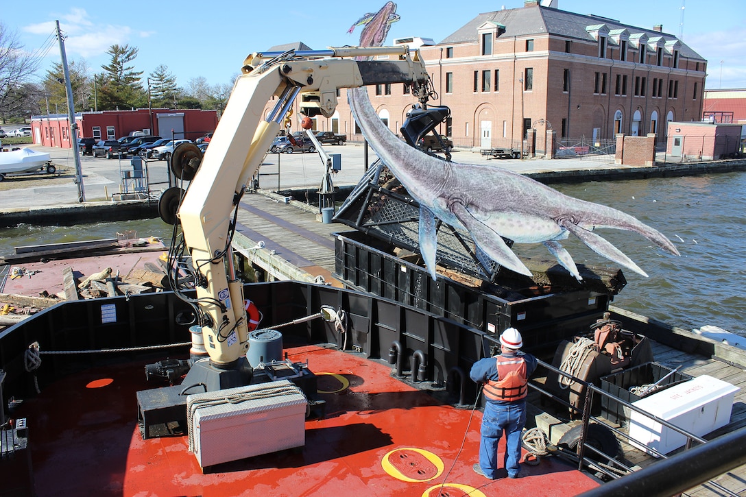 Debris Vessel Reynolds works to clear Chessie the Chesapeake Bay sea monster from the Baltimore Harbor Friday morning April 1, 2016.