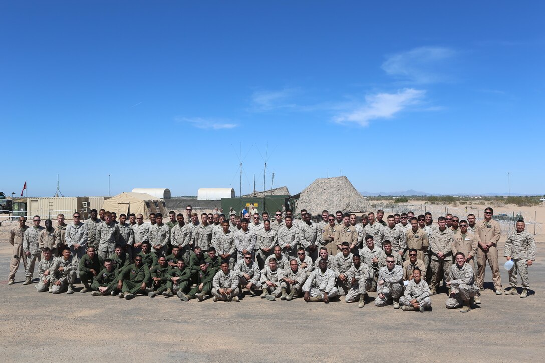 Marines with Marine Unmanned Aerial Vehicle Squadron (VMU) 1 pose together on the runway built by Marine Wing Support Squadron (MWSS) 371 and MWSS-274 at Cannon Air Defense Complex in Yuma, Ariz., March 25. In January, VMU-1 Marines began moving from Marine Corps Air-Ground Combat Center Twentynine Palms, Calif., to the Cannon Air Defense Complex with Marine Aircraft Group (MAG) 13, where they have access to the aerial support they needed to continue operations. (U.S. Marine Corps photo by Lance Cpl. Harley Robinson/Released)