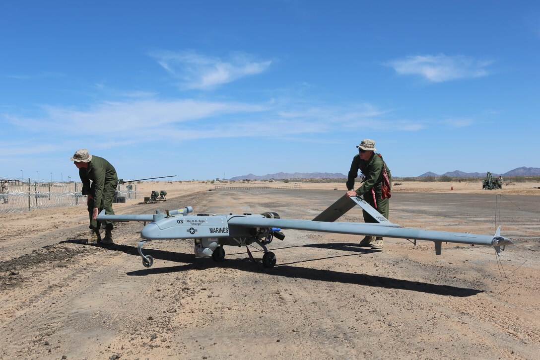 Marines with Marine Unmanned Aerial Vehicle Squadron (VMU) 1 rolls the RQ-7Bv2 Shadow, an unmanned aerial system, unto the runway at Cannon Air Defense Complex in Yuma, Ariz., March 25. Marine Wing Support Squadron (MWSS) 371 and MWSS-274 supported VMU-1 by building a runway in preparation for the Shadow’s first flight at the site. (U.S. Marine Corps photo by Lance Cpl. Harley Robinson/Released)