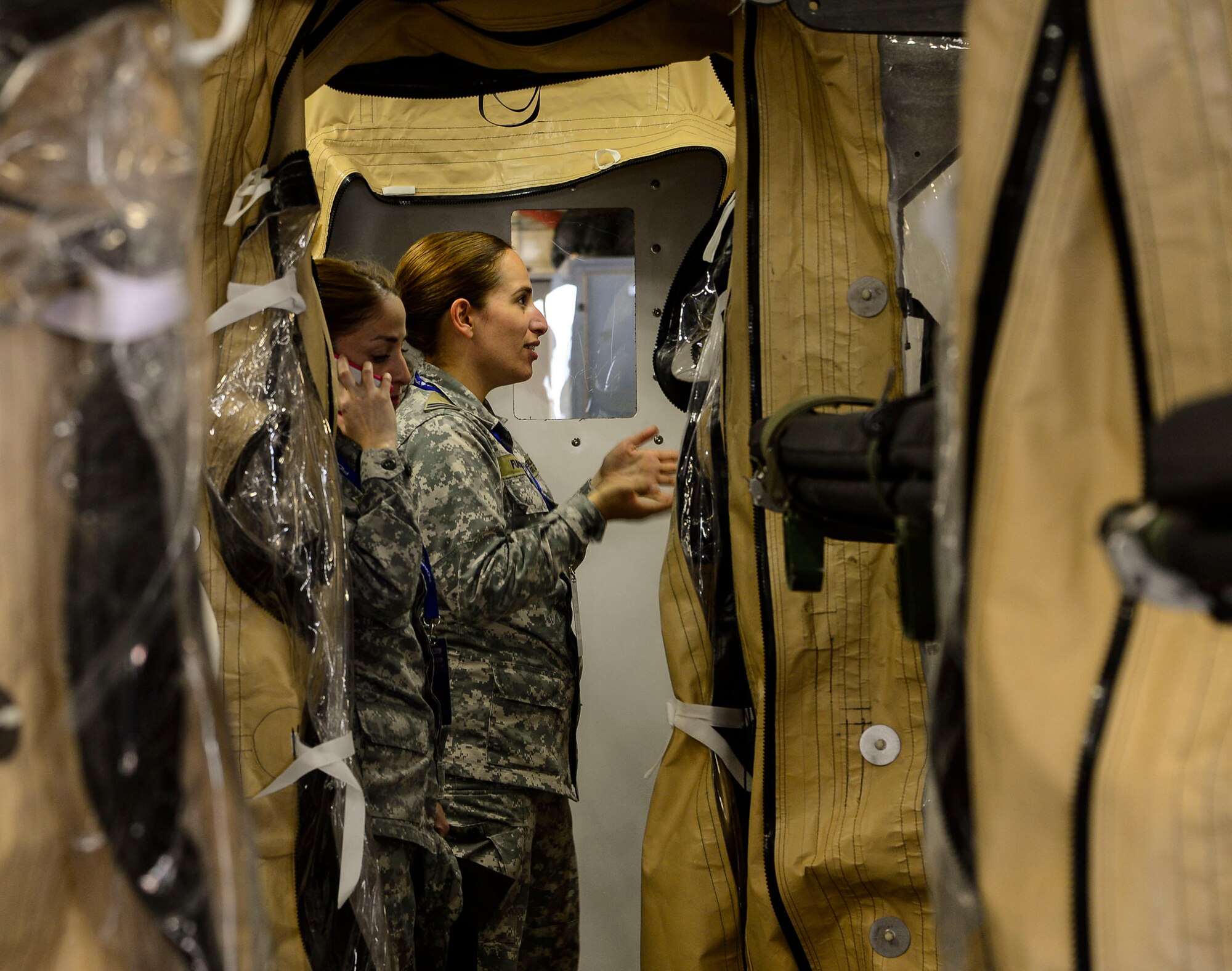 Chilean airmen ask questions concerning the use of the Transport Isolation System during a subject matter expert exchange at the 2016 FIDAE Air and Space Trade Show in Santiago, Chile, March 29, 2016. Exchanges are conducted regularly throughout the year and involve U.S. Airmen sharing best practices and procedures to build partnerships and promote interoperability with partner-nation air forces throughout South America, Central America and the Caribbean.  (U.S. Air Force photo by Tech. Sgt. Heather Redman/Released)