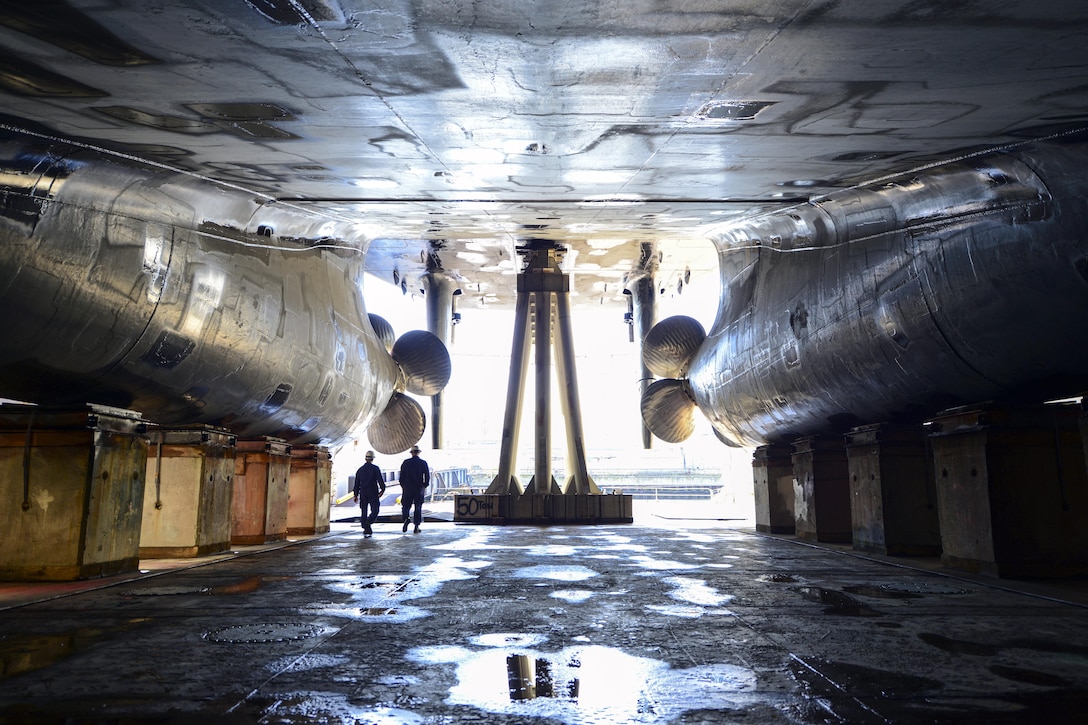 Navy Chief Petty Officer Mark Wanjongkhum and Chief Warrant Officer Michael Allen walk around the U.S. Coast Guard Cutter Healy in dry dock at Vigor Shipyard in Seattle, March 31, 2016. The Healy soon will return to the water after three months of maintainance. Wanjongkhum and Allen are assigned to the Surface Forces Logistics CenterCoast Guard photo by Petty Officer 1st Class Zac Crawford