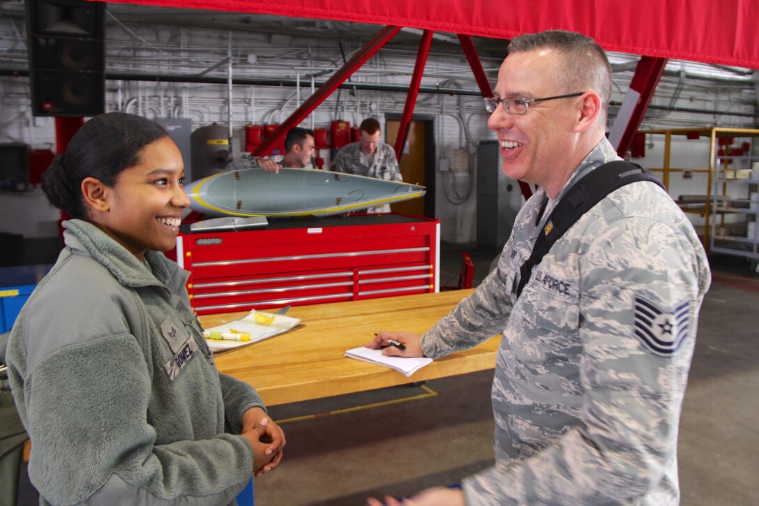 Senior Airman Debra Gomez, propulsion apprentice in the 932nd Airlift Wing Aircraft Maintenance Squadron, is interviewed by Tech. Sgt. Christopher Parr from the public affair shop.  Gomez's primary role is to help keep engines like this running smooth and flying.  She was spotlighted during Women's History Month recently, which started as a national celebration in 1981, when Congress authorized the president to proclaim the week beginning March 7, 1982, as Women's History Week. In 1987, Congress designated the month of March 1987 as Women's History Month.   (U.S. Air Force photo by Maj. Stan Paregien)