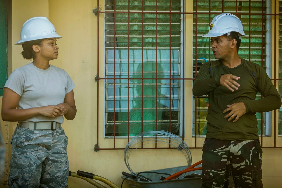 U.S. Air Force 1st Lt. Joy Johnson, left, engineer assigned to the 673D Expeditionary Engineer Squadron, discusses construction plans with a Philippine army soldier, right, at the Jaena Norte Elementary School, in Capiz, Philippines, as part of a humanitarian civic assistance (HCA) project during Exercise Balikatan 2016, March 29, 2016. The construction project is one of multiple HCAs taking place during this year's exercise, designed to improve the quality of life for the local populace and strengthen the bond between our two nations. Balikatan, which means "shoulder to shoulder" in Filipino, is an annual bilateral training exercise aimed at improving the ability of Philippine and U.S. military forces to work together during planning, contingency and humanitarian assistance and disaster relief operations. 