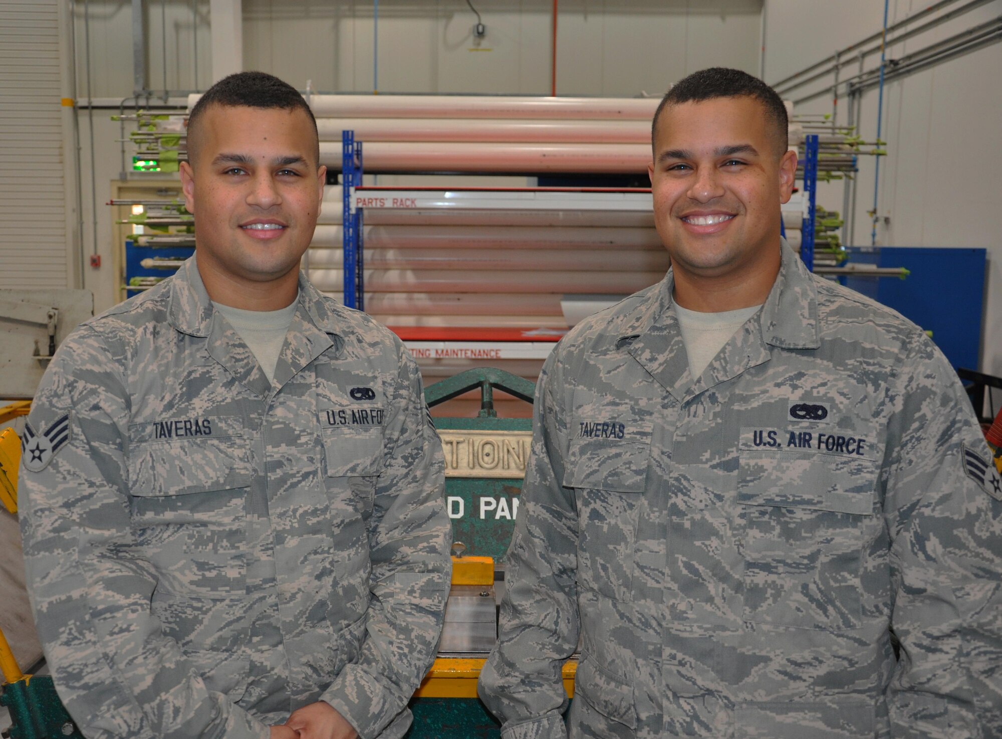 Senior Airman Carlos Taveras, left, a structural maintenance apprentice, disassembles a mandrel from a tube bender while his twin brother, Senior Airman Emmanuel Taveras, an aircraft electrical and environmental journeyman, looks on at Al Udeid Air Base, Qatar, March 17, 2016. The twin brothers, from the Bronx, New York, deployed with the 379th Expeditionary Maintenance Squadron in January. (U.S. Air Force photo/Tech. Sgt. James Hodgman)