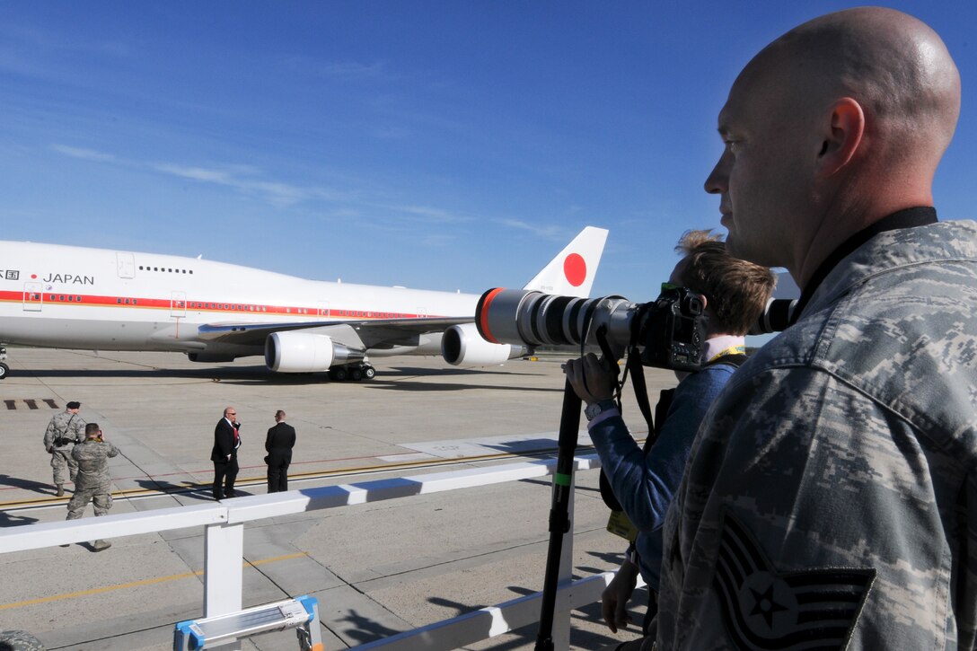Technical Sgt. Malachi Woodlee, 459th Maintenance Squadron repair/reclamation craftsman and Nuclear Security Summit volunteer, escorts members of civilian media during the arrival of Prime Minister Shinzo Abe of Japan on the Joint Base Andrews, Md., flight line March 30. More than 20 international heads of state arrived here for the 2016 NSS held in Washington, D.C. The summit provides a forum for leaders to reinforce commitments to securing nuclear materials. (U.S. Air Force photo/Staff Sgt. Kat Justen)