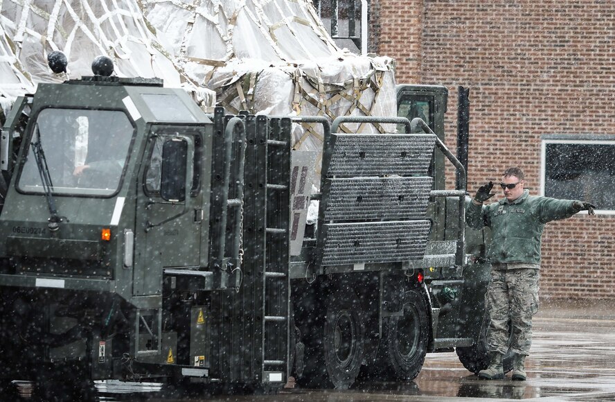 Senior Airman Nicholas Graff, 27th Aerial Port Squadron, guides a K loader to place cargo inside a KC-10 aircraft. (Air Force Photo/Paul Zadach)

