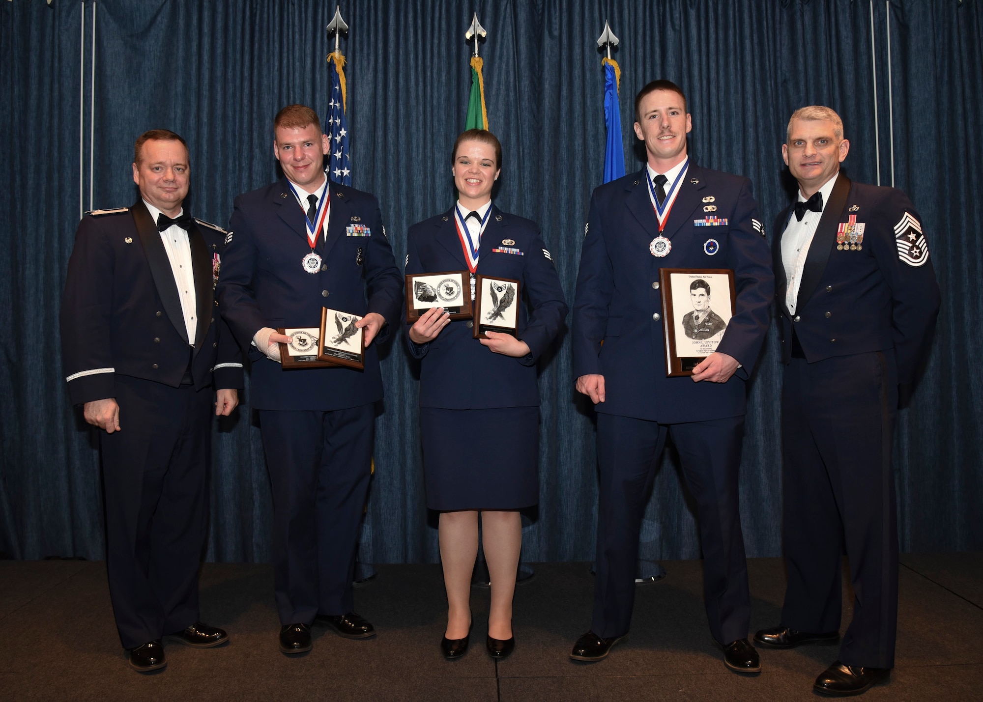 Airmen of Airman Leadership School Class 16 Charlie, who earned top honors, pose for a photo with Col. Brian McDaniel, 92nd Air Refueling Wing commander, and Chief Master Sgt. Christian Pugh, 92nd ARW command chief, March 31, 2016, at Fairchild Air Force Base, Wash. ALS is a five-week course that focuses on leadership abilities, profession of arms and effective communication in the workplace. (U.S. Air Force photo/Airman 1st Class Mackenzie Richardson)