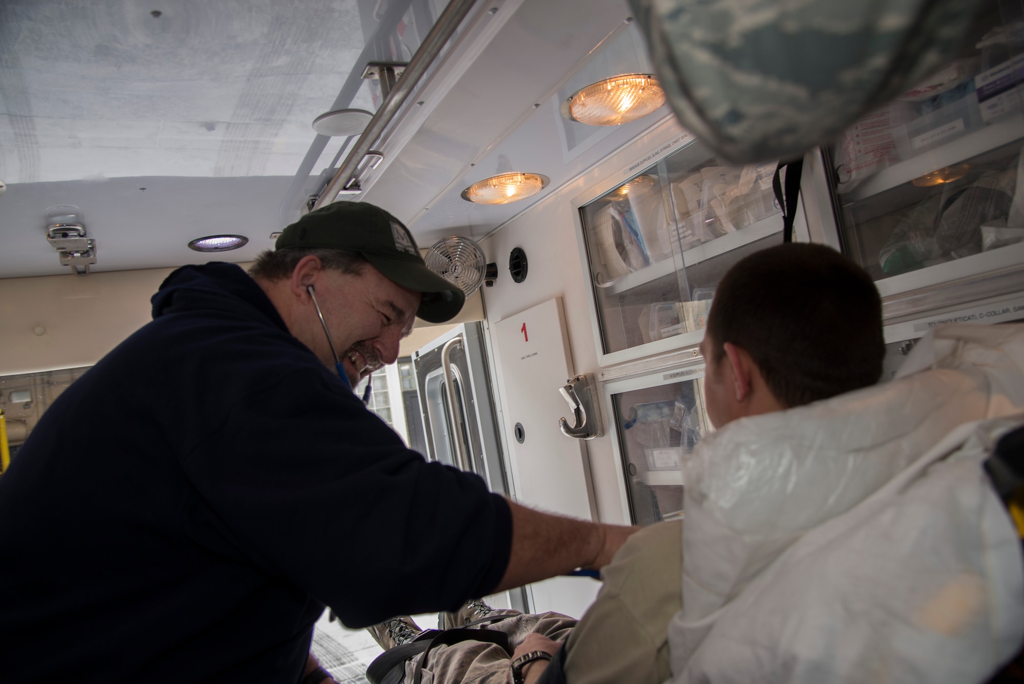 Gary August, 5th Medical Group field paramedic, checks the vitals of a patient during a simulated response at Minot Air Force Base, N.D., March 18, 2016. Personnel in August’s section are trained to work with LIFEPAK15 cardiac monitors, stair chairs, backboards and a host of other emergency medical equipment. (U.S. Air Force photo/Airman 1st Class Christian Sullivan)