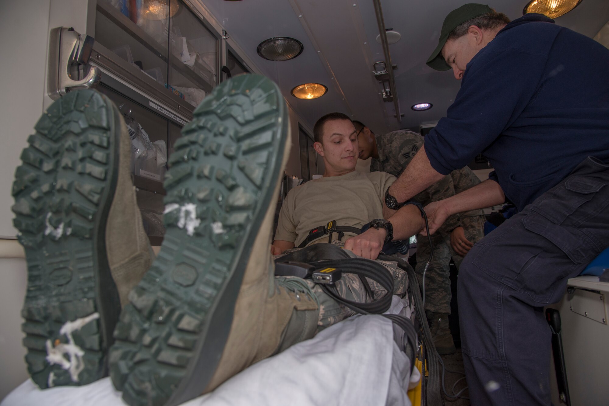 Gary August, 5th Medical Group field paramedic, checks the vitals of a patient during a simulated response at Minot Air Force Base, N.D., March 18, 2016. Personnel in August’s section are trained to work with LIFEPAK15 cardiac monitors, stair chairs, backboards and a host of other emergency medical equipment. (U.S. Air Force photo/Airman 1st Class Christian Sullivan)