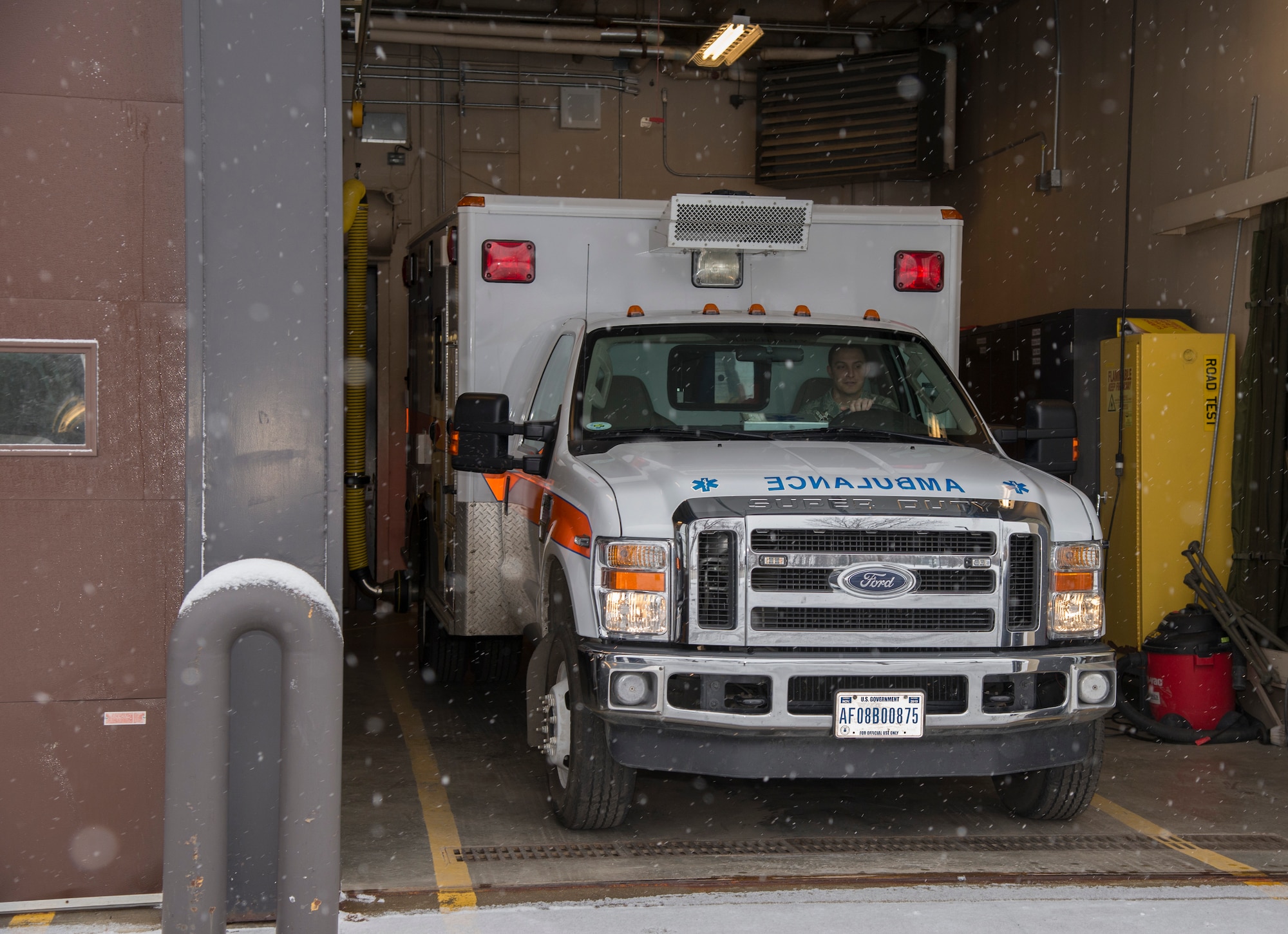 Staff Sgt. Brent Stacy, 5th Medical Group emergency medical technician, takes the ambulance out of the garage during a simulated response at Minot Air Force Base, N.D., March 18, 2016. . Stacy and other civilian paramedics in his section work 24 to 72 hour shifts supporting the medical needs of base Airmen and their families.  (U.S. Air Force photo/Airman 1st Class Christian Sullivan)