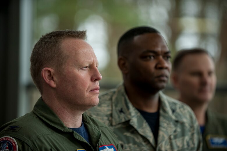 (From left to right) U.S. Air Force Col. Joe McFall, 52nd Fighter Wing commander, Col. Alfred Flowers, 52nd Medical Group commander, and Col. Timothy Robinette, U.S. Air Forces in Europe and Air Forces Africa command surgeon, stand at the positon of attention during to the German and United States National Anthems during the 52nd Medical Group/Landstuhl Regional Medical Center Telehealth ribbon cutting inside the 52nd MDG clinic April 1, 2016, at Spangdahlem Air Base, Germany. The ceremony marked the inaugural Department of Defense Telehealth program, which will allow patients from Spangdahlem Air Base to receive treatment from LRMC doctors without leaving the installation.. (U.S. Air Force photo by Senior Airman Rusty Frank/Released)
