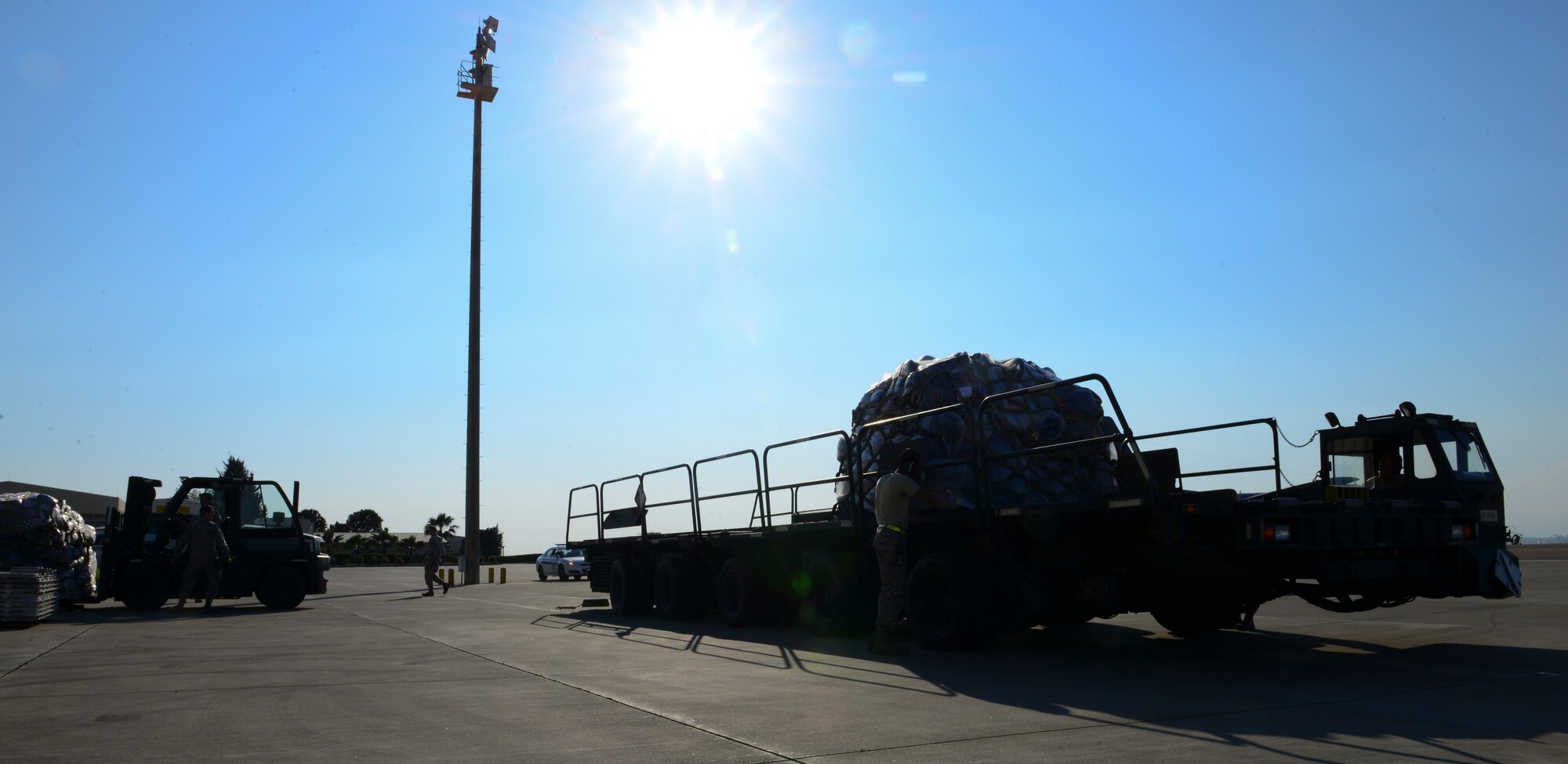 Members of the 728th Air Mobility Squadron load a Halverson lift with luggage, March 31, 2016, at Incirlik Air Base, Turkey. The 728th AMS built, staged and transported the pallets to load in an aircraft to aid in the process of an ordered departure. (U.S. Air Force photo by Staff Sgt. Caleb Pierce/Released)