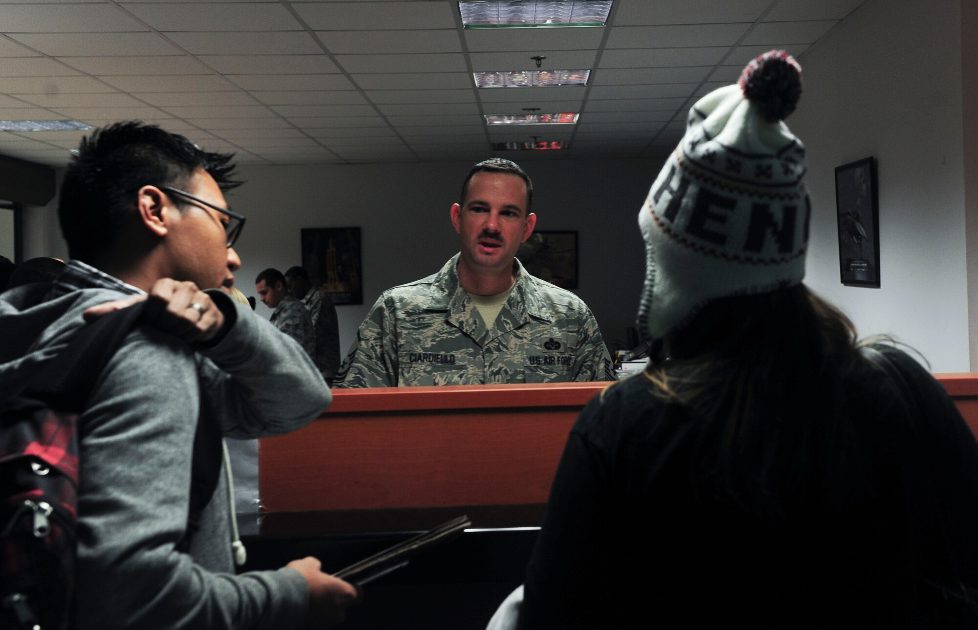 U.S. Air Force Master Sgt. Marc Ciardiello, 39th Air Base Wing legal office superintendent, speaks with U.S. Air Force Staff Sgt. Bryant Guillermo, 39th Security Forces Squadron NCO in-charge of investigation, and his wife at the processing center during the Department of State ordered departure March 30, 2016 at Incirlik Air Base, Turkey. The directed departure was conducted in close coordination with the Department of State and the Government of Turkey to ensure the safe transition of U.S. citizens from Incirlik Air Base and elsewhere in Turkey. (U.S. Air Force photo by Staff Sgt. Eboni Reams/Released)