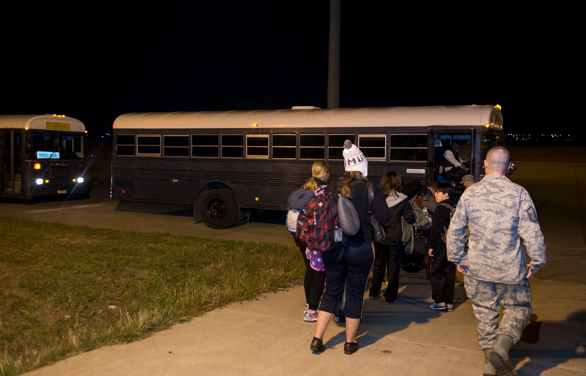 Families of U.S. Airmen and Department of Defense civilians board a bus to be taken to the passenger terminal during an ordered departure March 30, 2016 at Incirlik Air Base, Turkey. U.S. forces stationed at Incirlik Air Base aided in the transportation of citizens returning to the United States. (U.S. Air Force photo by Staff Sgt. Eboni Reams/Released)