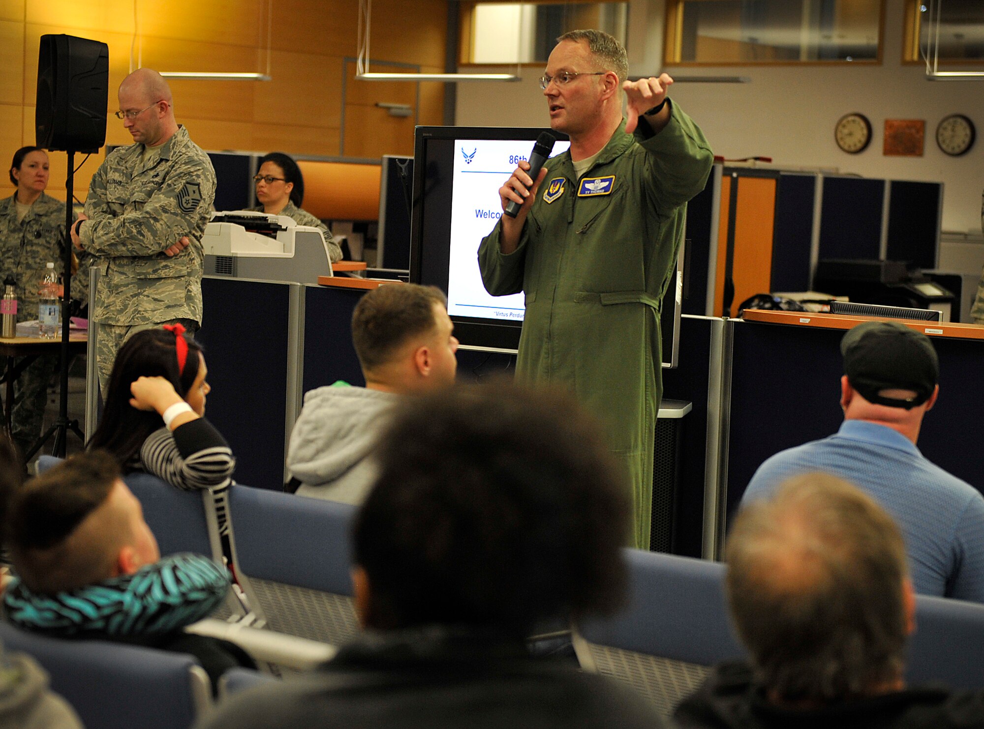 Brig. Gen. Jon T. Thomas, 86th Airlift Wing commander, talks to families arriving from Turkey about what agencies are available to assist during their transition March 31, 2016, at Ramstein Air Base, Germany. Many Airmen and civilians came together to provide child care, transportation, medical assistance and essentials to families evacuating military bases in Turkey. (U.S. Senior Airman Larissa Greatwood)