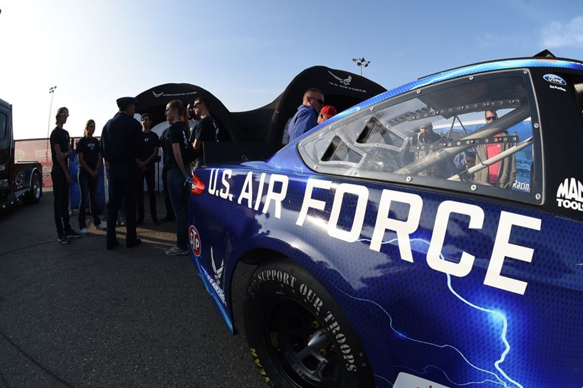 Lt. Gen. Samuel Greaves, SMC commander and Air Force program executive office for space, visits with Air Force Delayed Entry recruits in the pit area during a racing event at the Auto Club Speedway, March 20. (US Air Force photo/Joe Juarez)

