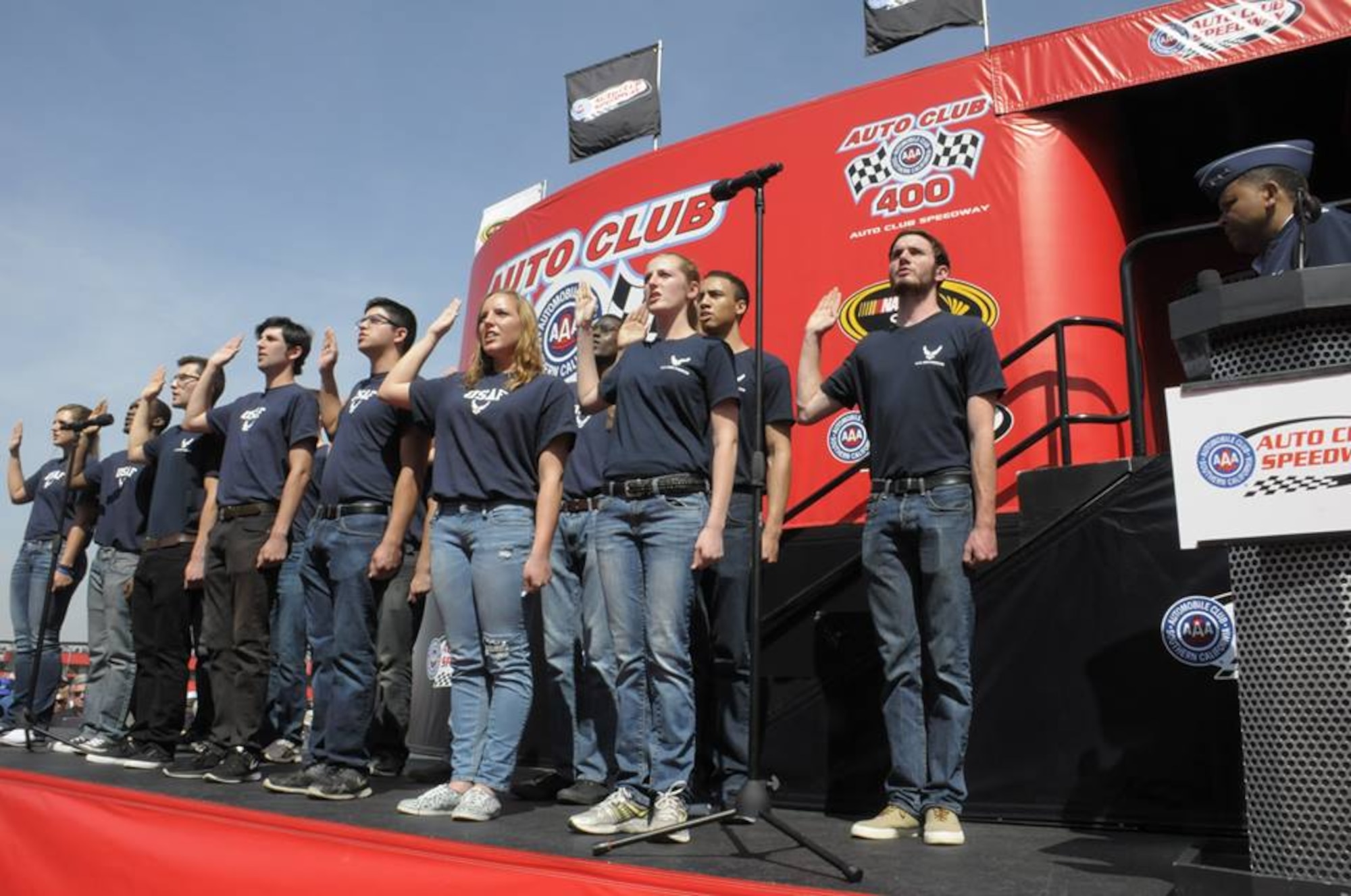 Lt. Gen. Samuel Greaves, SMC commander and Air Force program executive office for space, administers the oath of enlistment for Air Force Delayed Entry recruits during a racing event at the Auto Club Speedway, March 20. (US Air Force photo/Joe Juarez)

