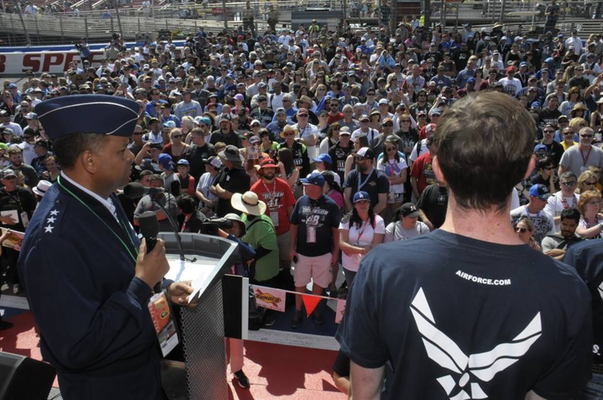 Lt. Gen. Samuel Greaves, SMC commander and Air Force program executive office for space, administers the oath of enlistment for Air Force Delayed Entry recruits during a racing event at the Auto Club Speedway, March 20. (US Air Force photo/Joe Juarez)

