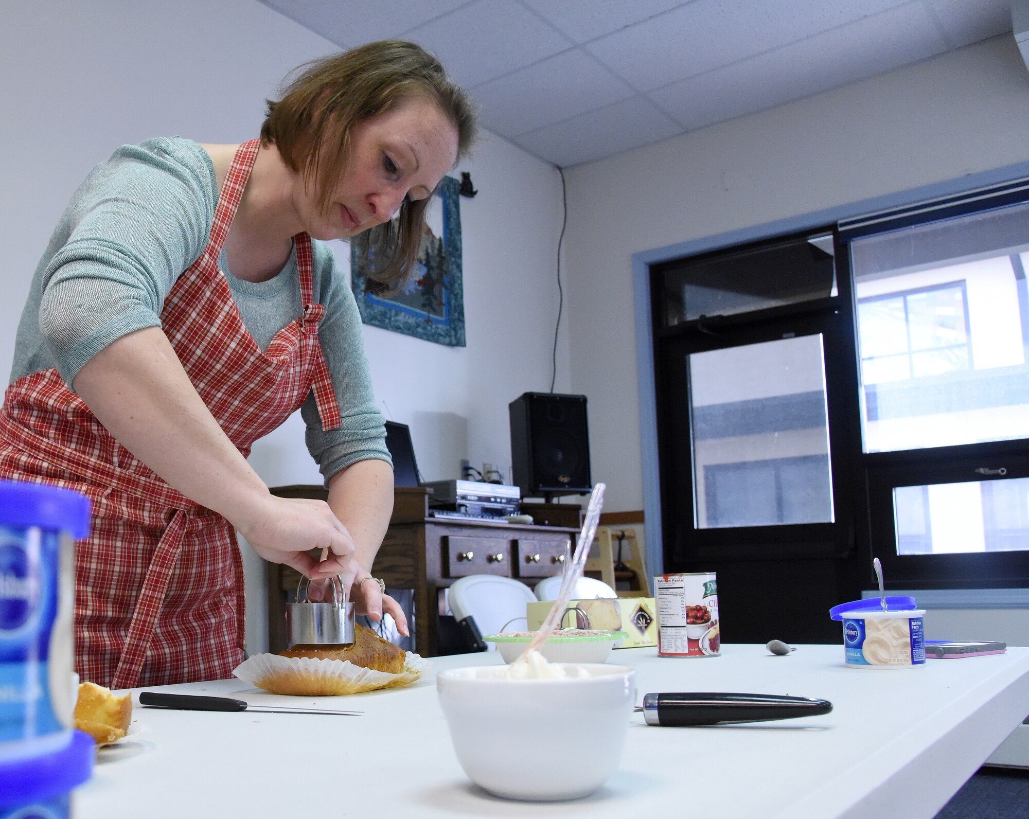 Master Sgt. Micheal Filipovich, 341st Logistics Readiness Squadron first sergeant and cooking club coordinator, demonstrates how to cut the center from a cake March 31, 2016, at the first cooking club at Malmstrom Air Force Base, Mont. Filipovich taught attendees how to make a dessert using only ingredients purchased from a dollar store. (U.S. Air Force photo/Senior Airman Jaeda Tookes)


