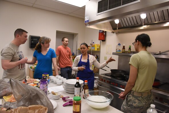 Master Sgt. Sherry Matthews, 341st Civil Engineer Squadron operations management section chief and cooking club coordinator, teaches a class to make stir-fry March 31, 2016, at the first cooking club at Malmstrom Air Force Base, Mont. The cooking club gives individuals a chance to socialize, while learning to cook a simple, yet healthy meal. (U.S. Air Force photo/Senior Airman Jaeda Tookes)

